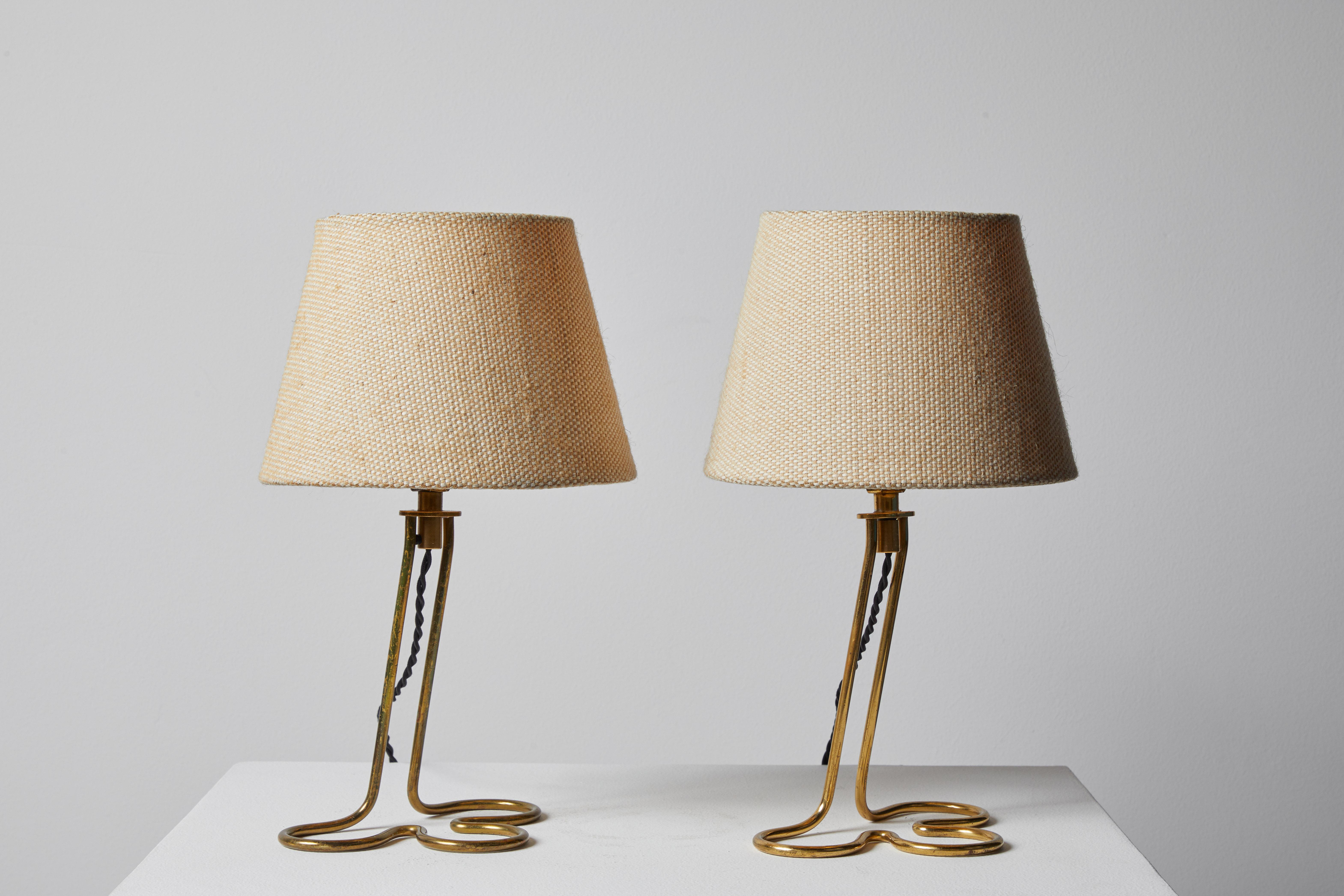Pair of Table/Wall Lights by Mauri Almari for Idman Oy. Designed and manufactured in Finland, circa 1950s. Brass base, textured linen shades. Can be mounted on wall or used as table lamps. Each light takes one E27 75w maximum bulb. Bulbs provided as