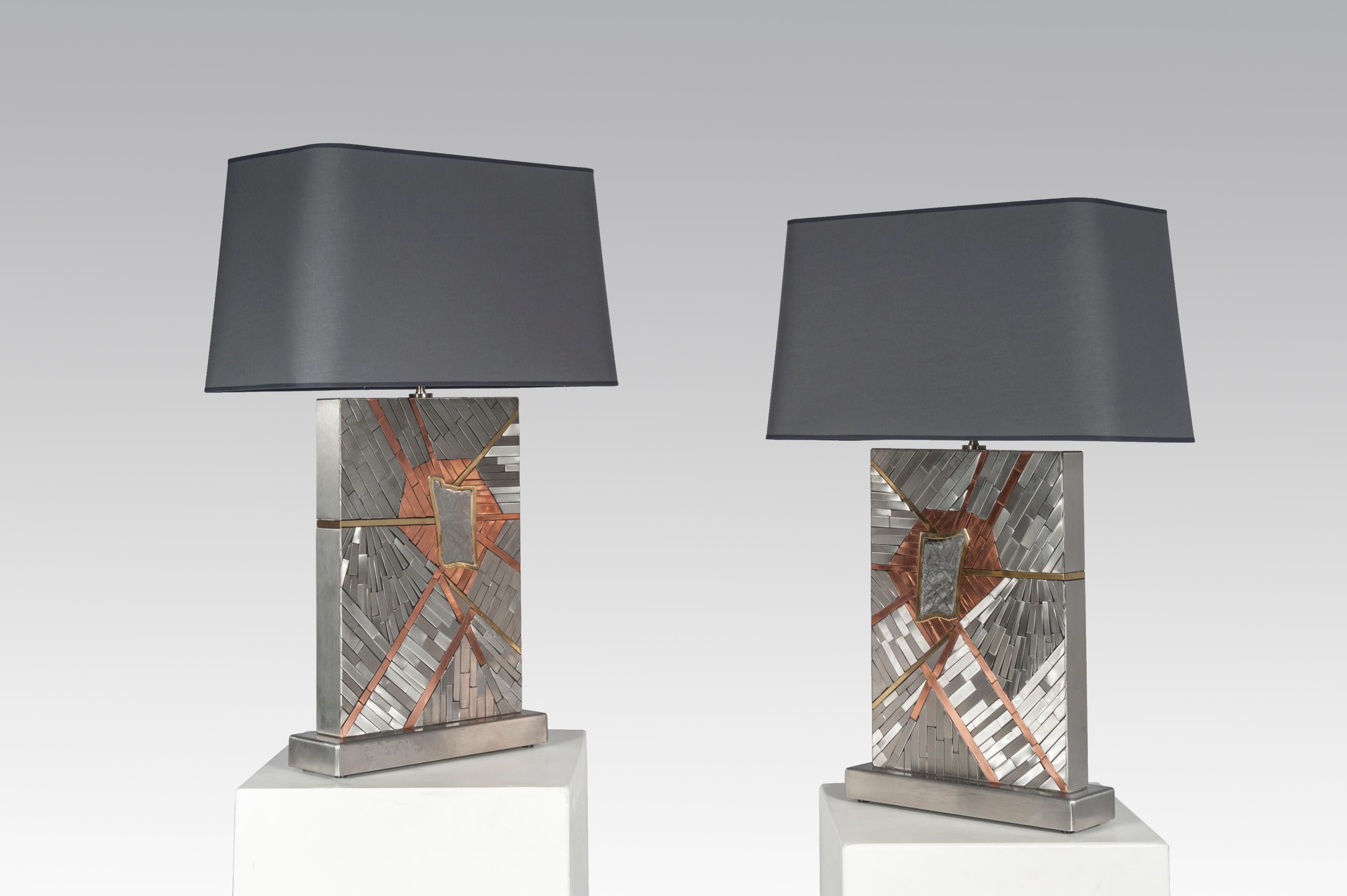 Created to measure by Stan Usel, this pair detail of red copper, stainless steel and brass table lamps topped with a magnificent meteorite gemstone highlighting a mosaic radiation. Each piece is topped with a unique stone and when put together aside