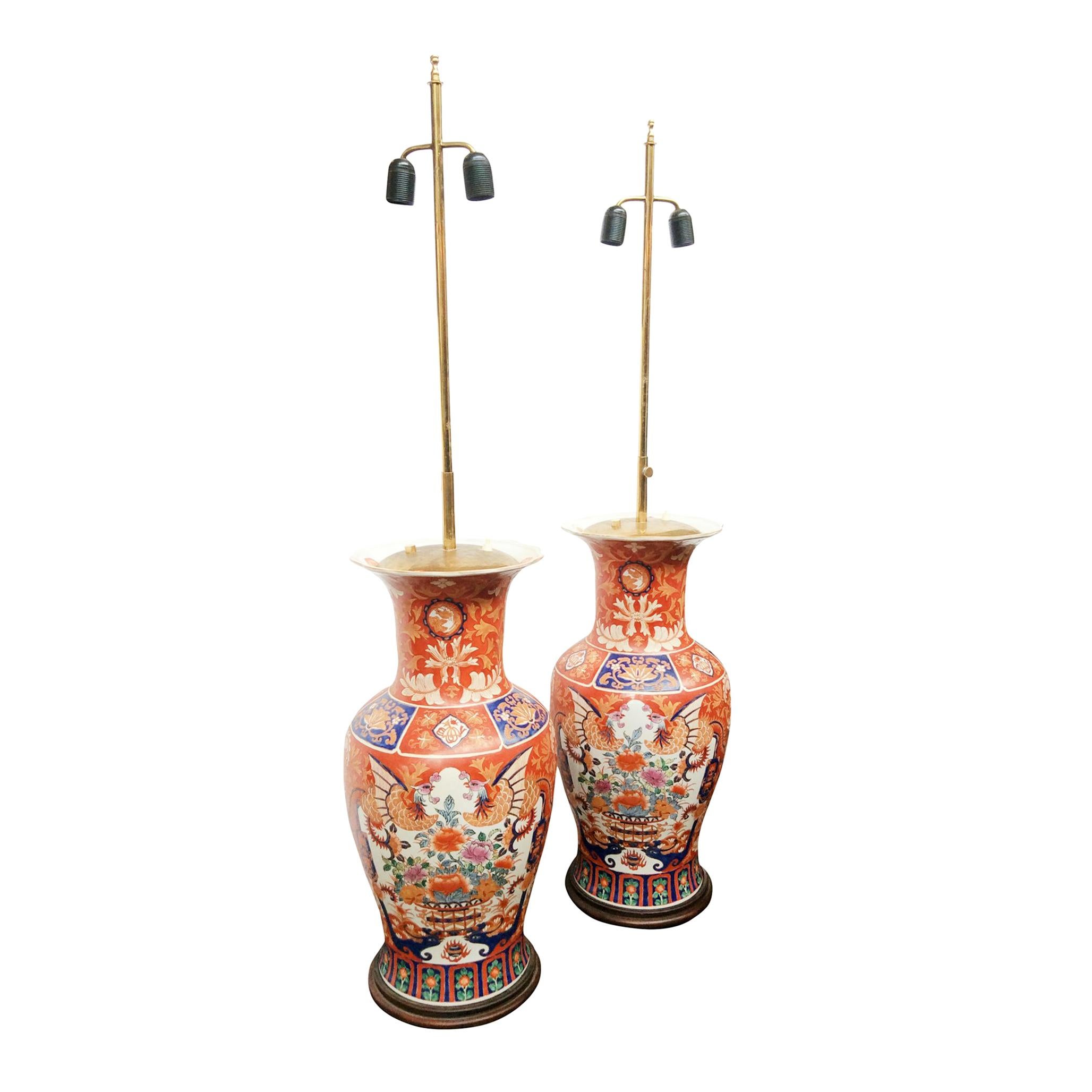 An exceptional pair of Imari table lamps. Handcrafted in the 1940s. Influenced by the bold colors of Arati ware from Japan. This pair is comprised of hand painted ceramic vase bodies decorated in a palette of red, yellow, orange, white, blue, and