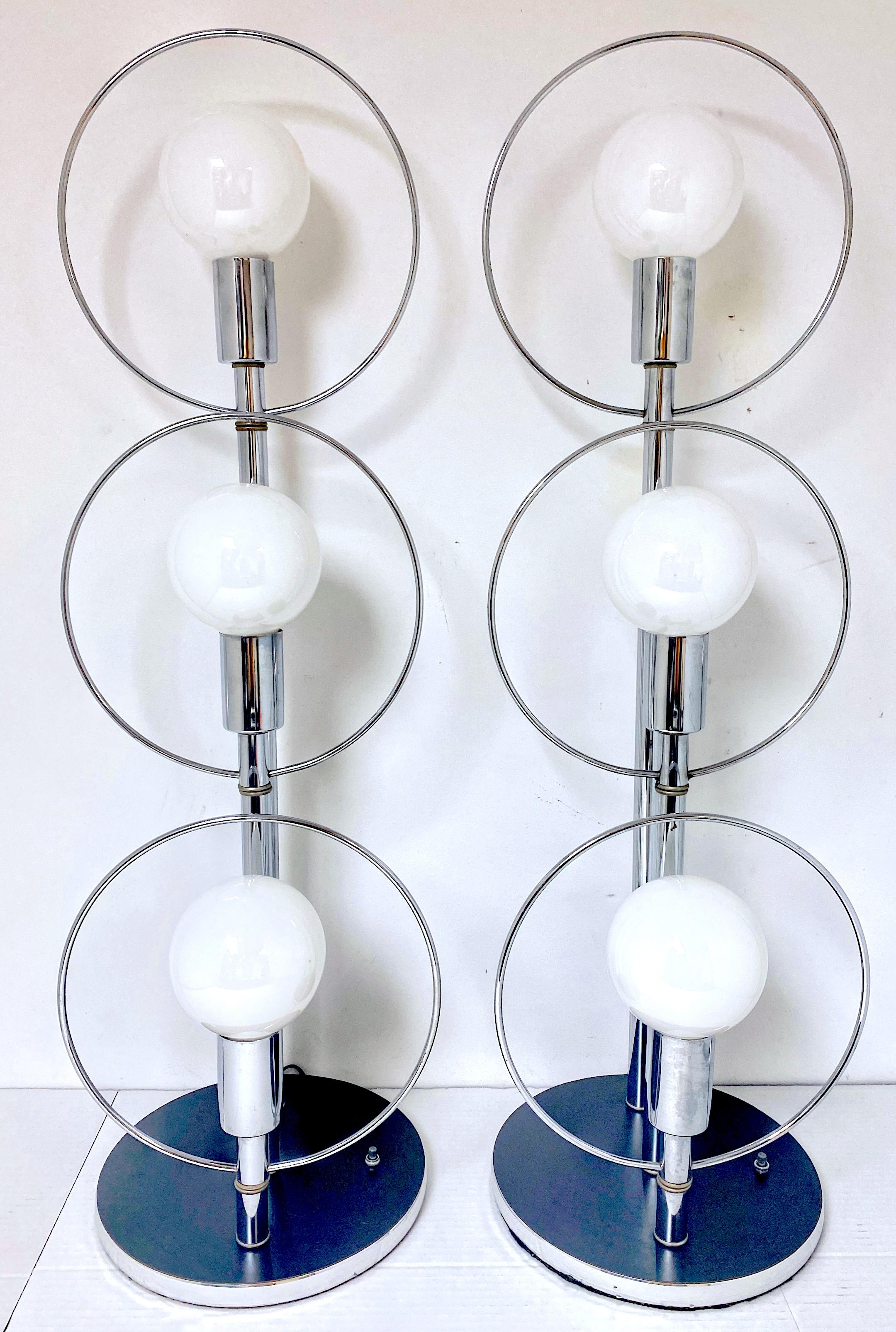 Pair of Tall 70s' polished Chrome Mod Ring Lamps, Attributed to Robert Sonneman USA, Circa 1970s 

This striking pair of tall 1970s polished chrome mod ring lamps, attributed to the renowned designer Robert Sonneman, epitomizes the bold and