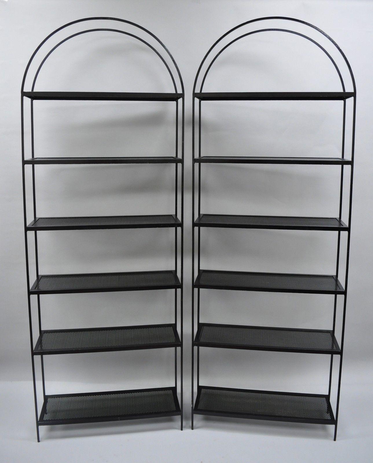 Vintage pair of tall arched iron mid-century modern bookcase shelves. Item features six mesh shelves, tall narrow form, heavy iron construction, a few drill holes from original wall mounting (image 9), and clean modernist lines, circa mid-20th