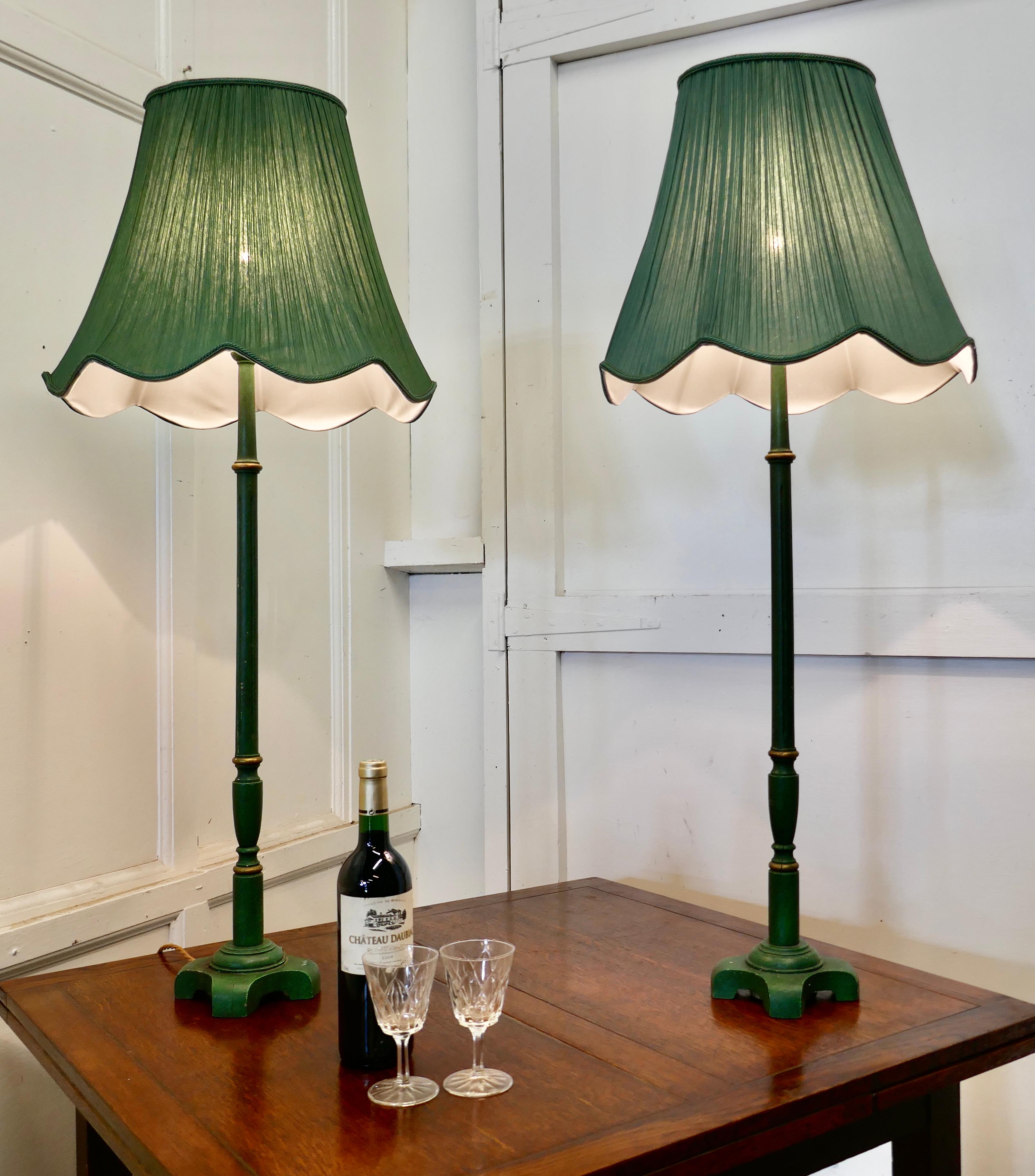 Pair of tall Art Deco green table lamps

These are a very stylish pair of Art Deco lamps
The lamps are tall and made in wood with matching lampshades
The linen covered shades are lined and pleated with scalloped shape at the bottom, the wiring