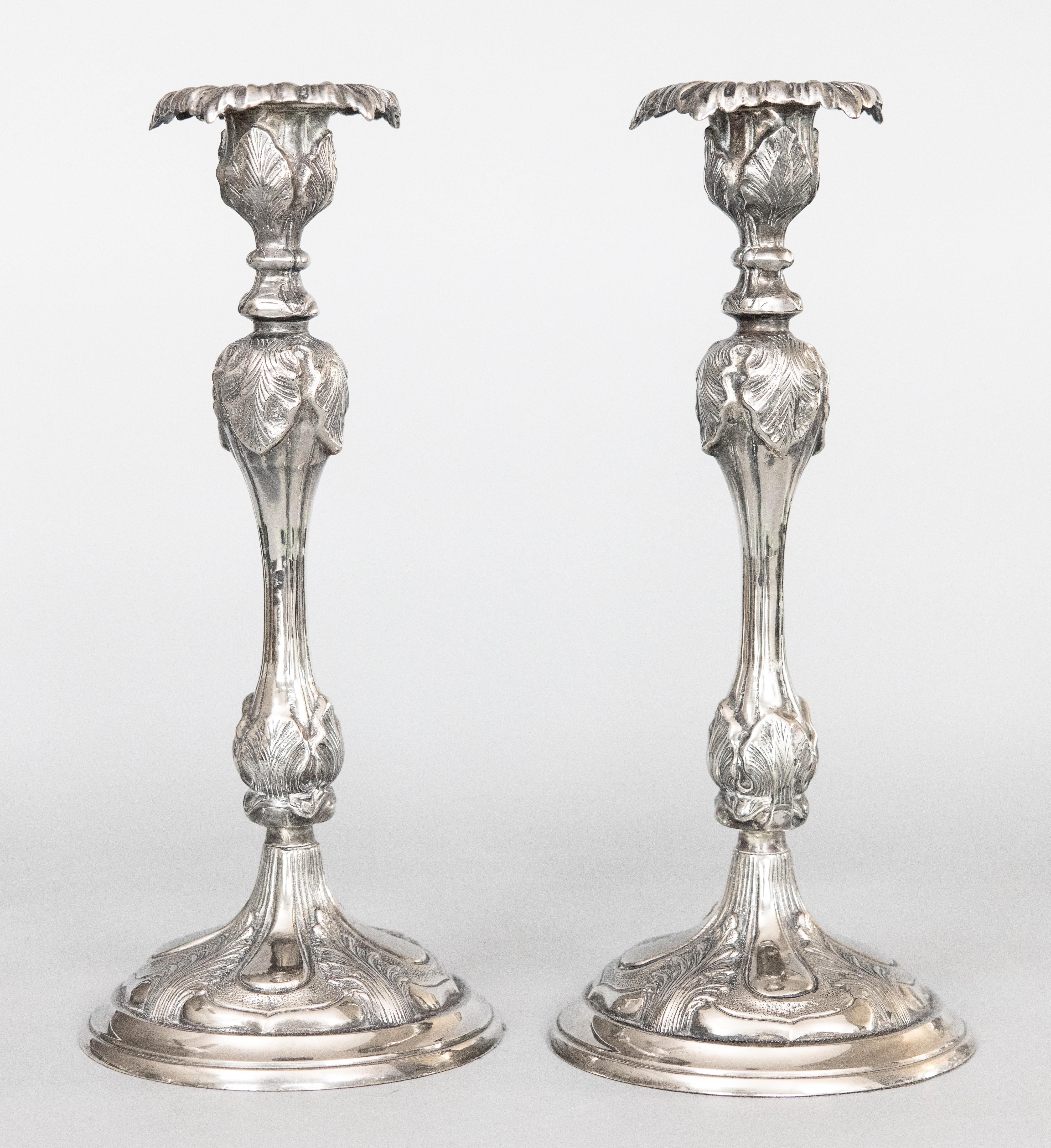 A fabulous tall pair of antique Art Nouveau English silverplated candlesticks, circa 1900. These gorgeous candle holders are a nice large size and heavy, together weighing over 5 1/2 lbs, with a stylish acanthus leaf design in a lovely aged silver