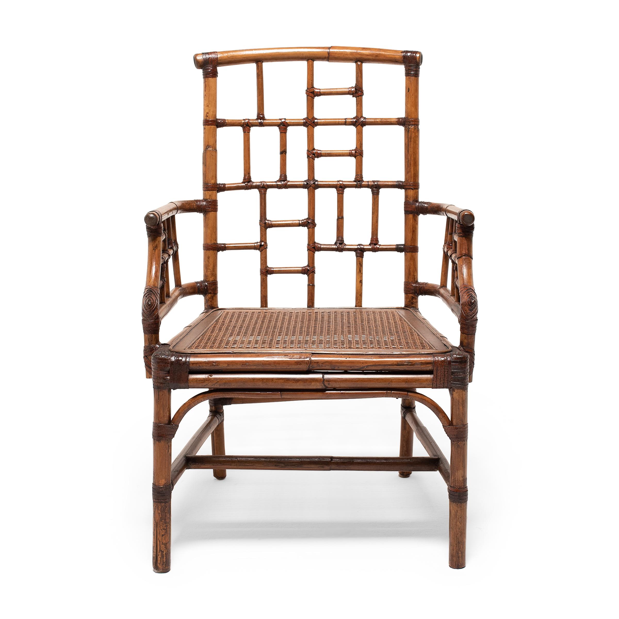 A pair of tall-back armchairs crafted of bent bamboo in a traditional style known as the 'southern official's hat chair.'  Woven rattan seat. 