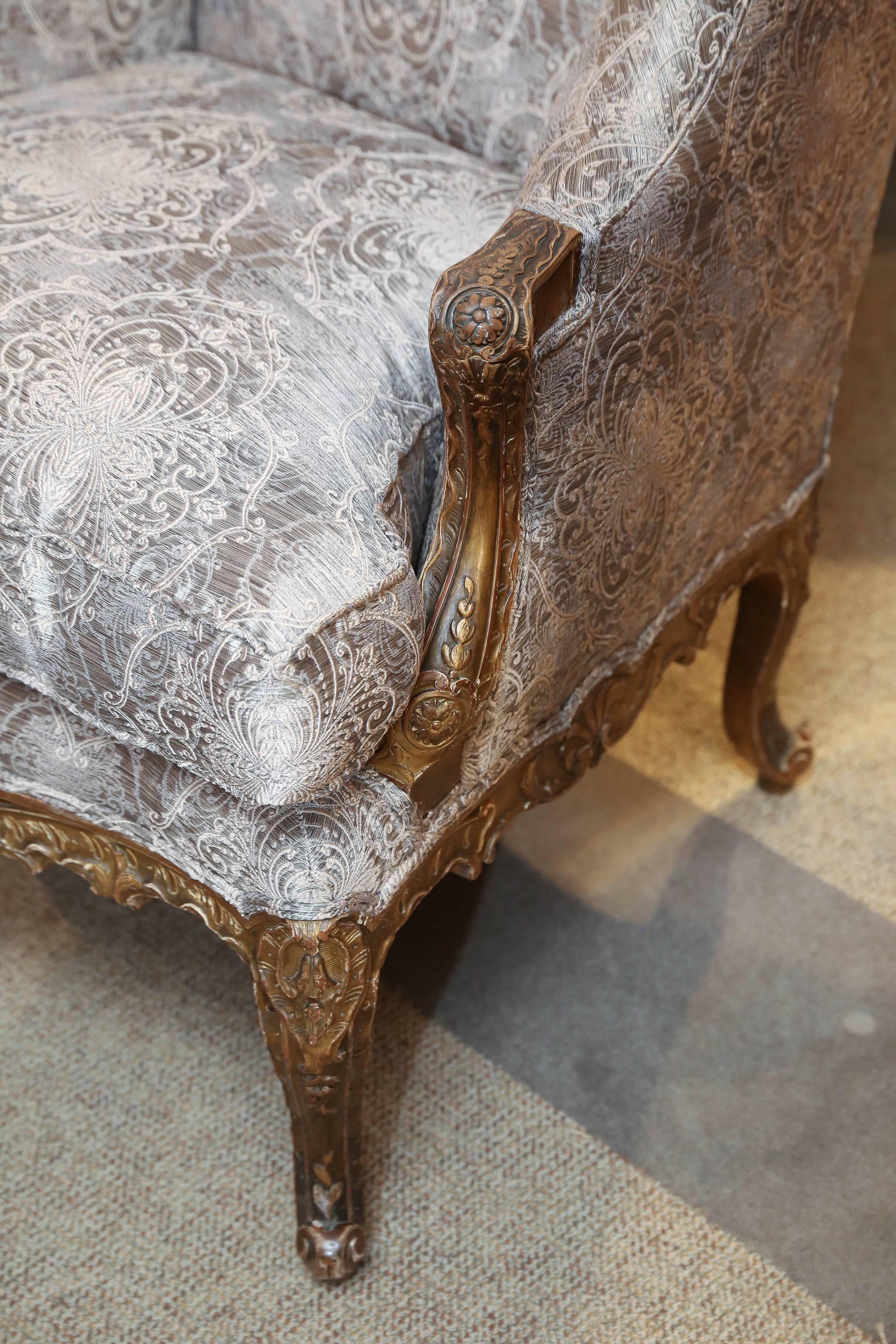 19th century giltwood chairs with elegant tall back
New upholstery in designer fabric in a gold hue
Frames have original gilding and the patina is
A beautiful soft gold color.