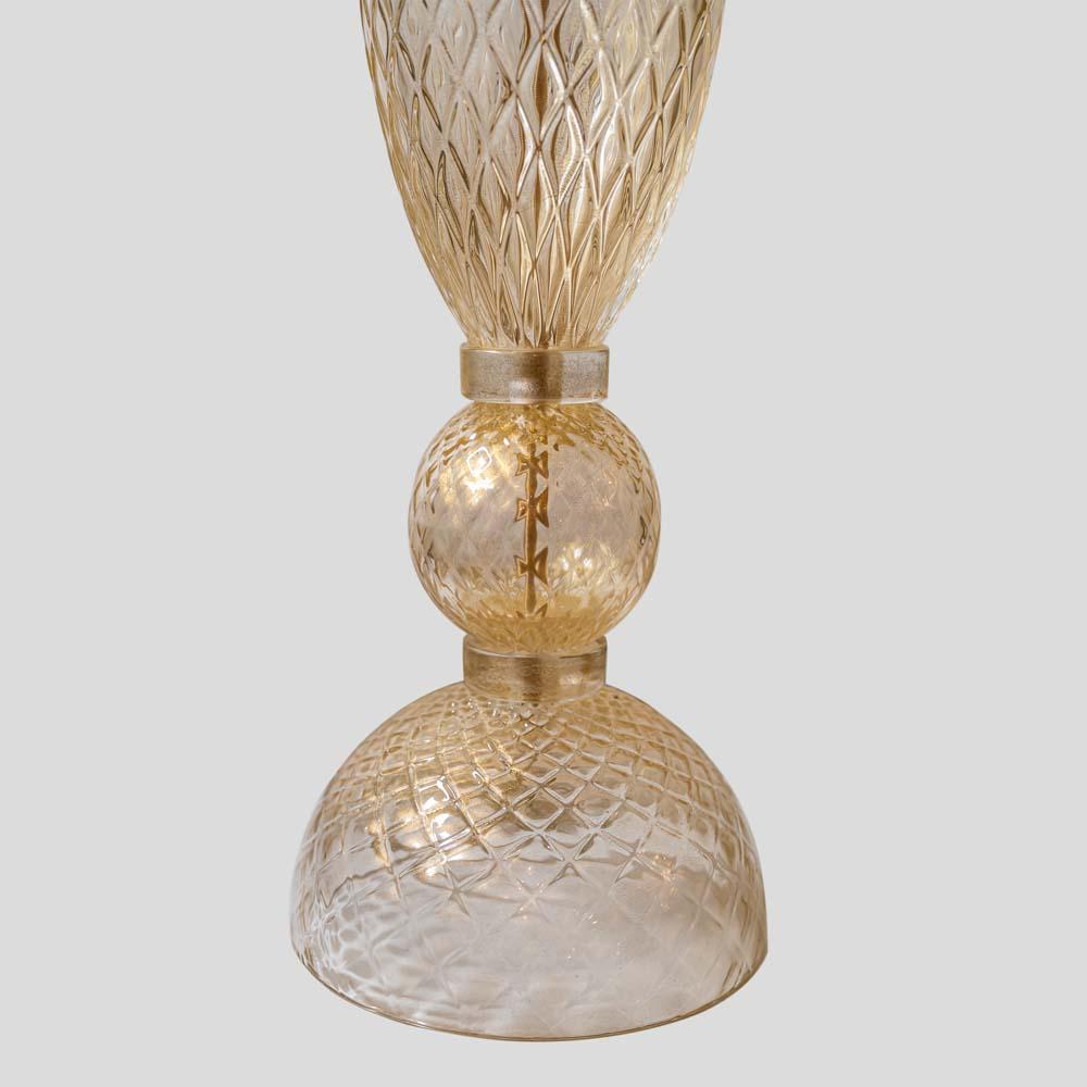 A beautiful  pair of tall table lamps blown Murano clear glass with gold inclusions, hand worked Romboidal lines on the glass surface two spheres with a central oval part.