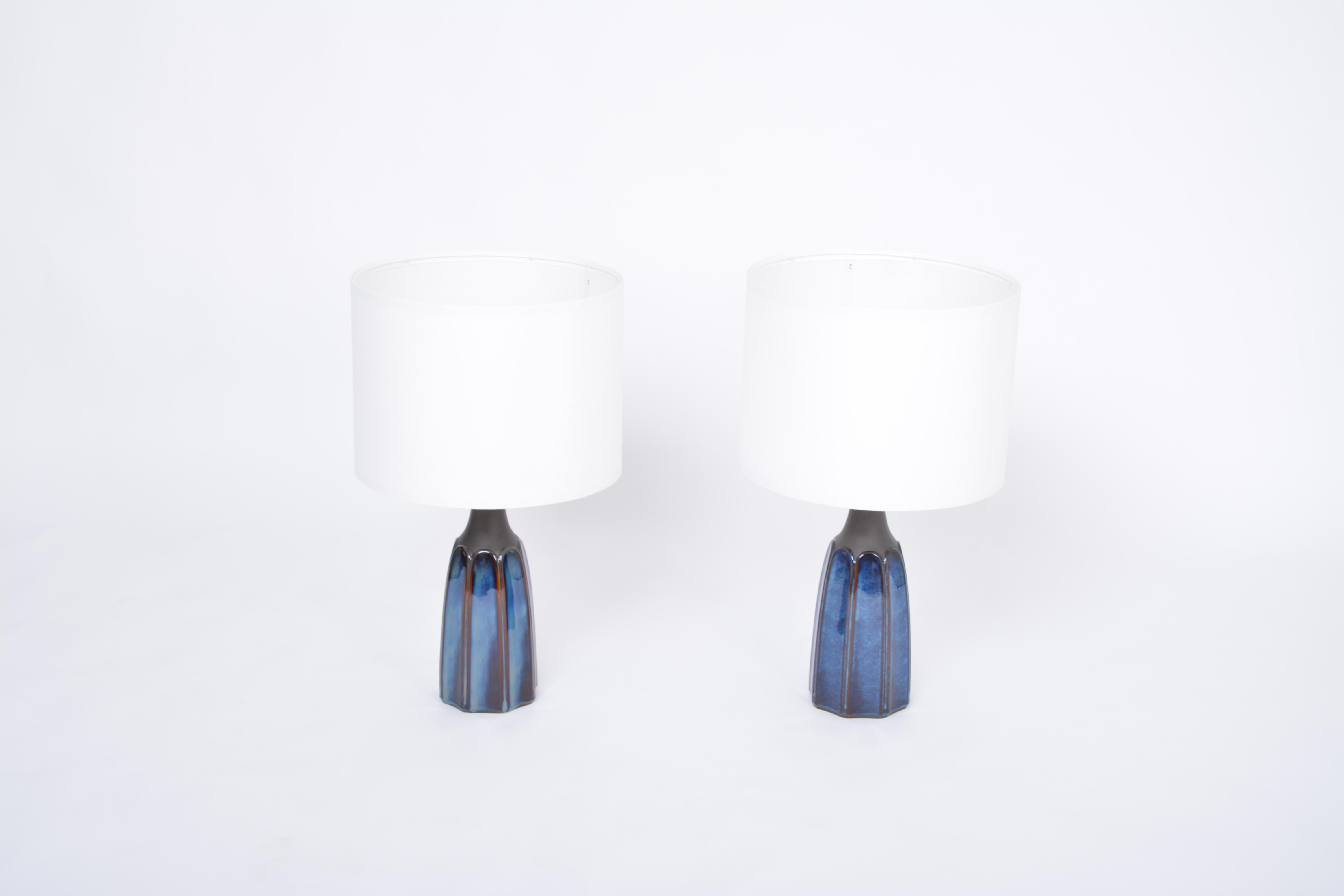Pair of tall blue stoneware table lamps model 1042 by Einar Johansen for Søholm

Pair of table lamps made of stoneware with blue ceramic glazing to the base of the lamps. Designed by Einar Johansen and produced by Danish company Soholm. The base