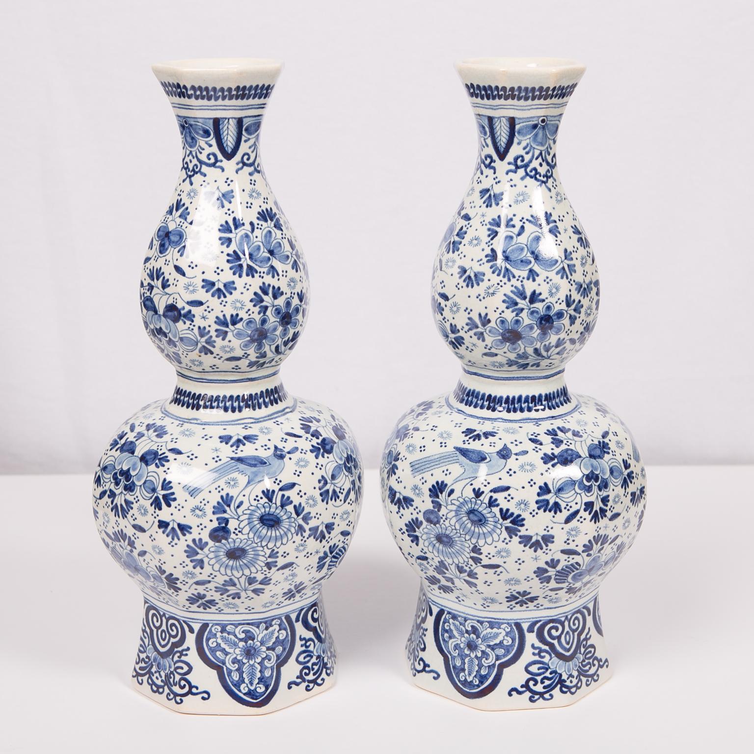 A pair of tall, octagonal Dutch Delft blue and white vases with 
