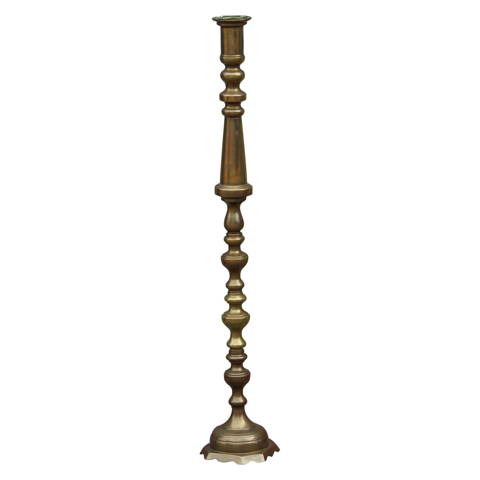 Elegant pair of tall brass candlesticks from the mid-20th century. One of the candlesticks has a carving in cursive for the Lions of District 2T3.