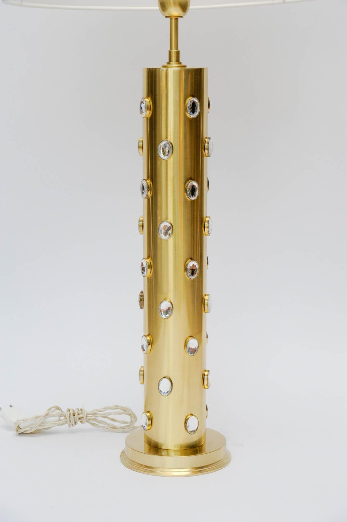 Pair of tall lamps made of satin brass with tens of small glass sparkles set all-over them.