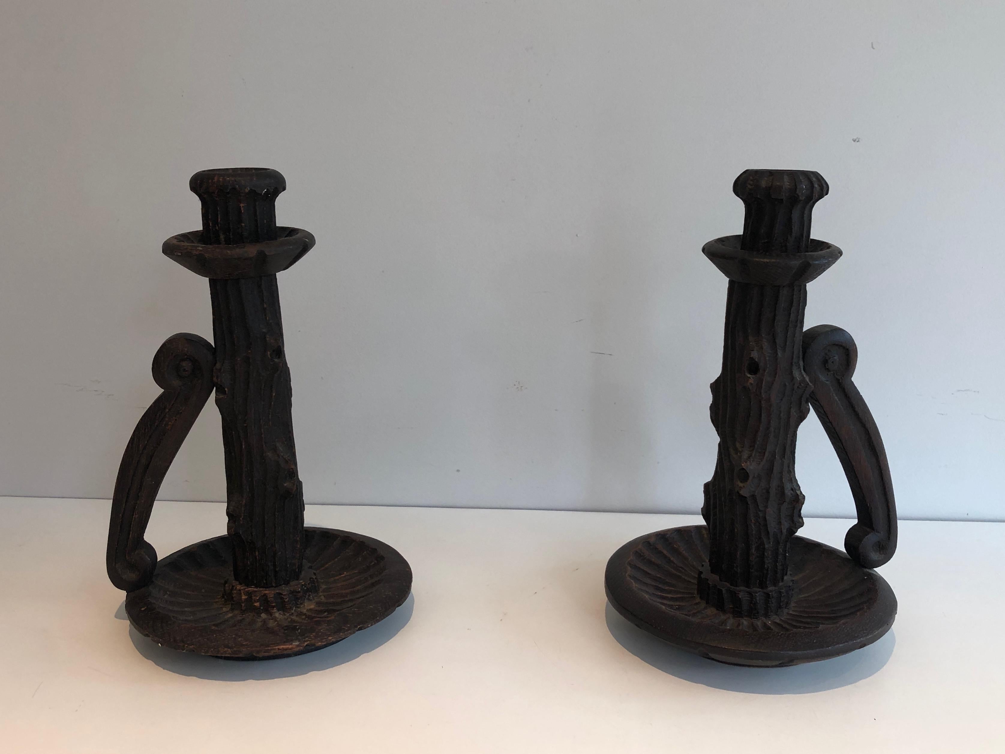 This pair of tall brutalist candle holders are made of carved wood. This is a French work, circa 1950.