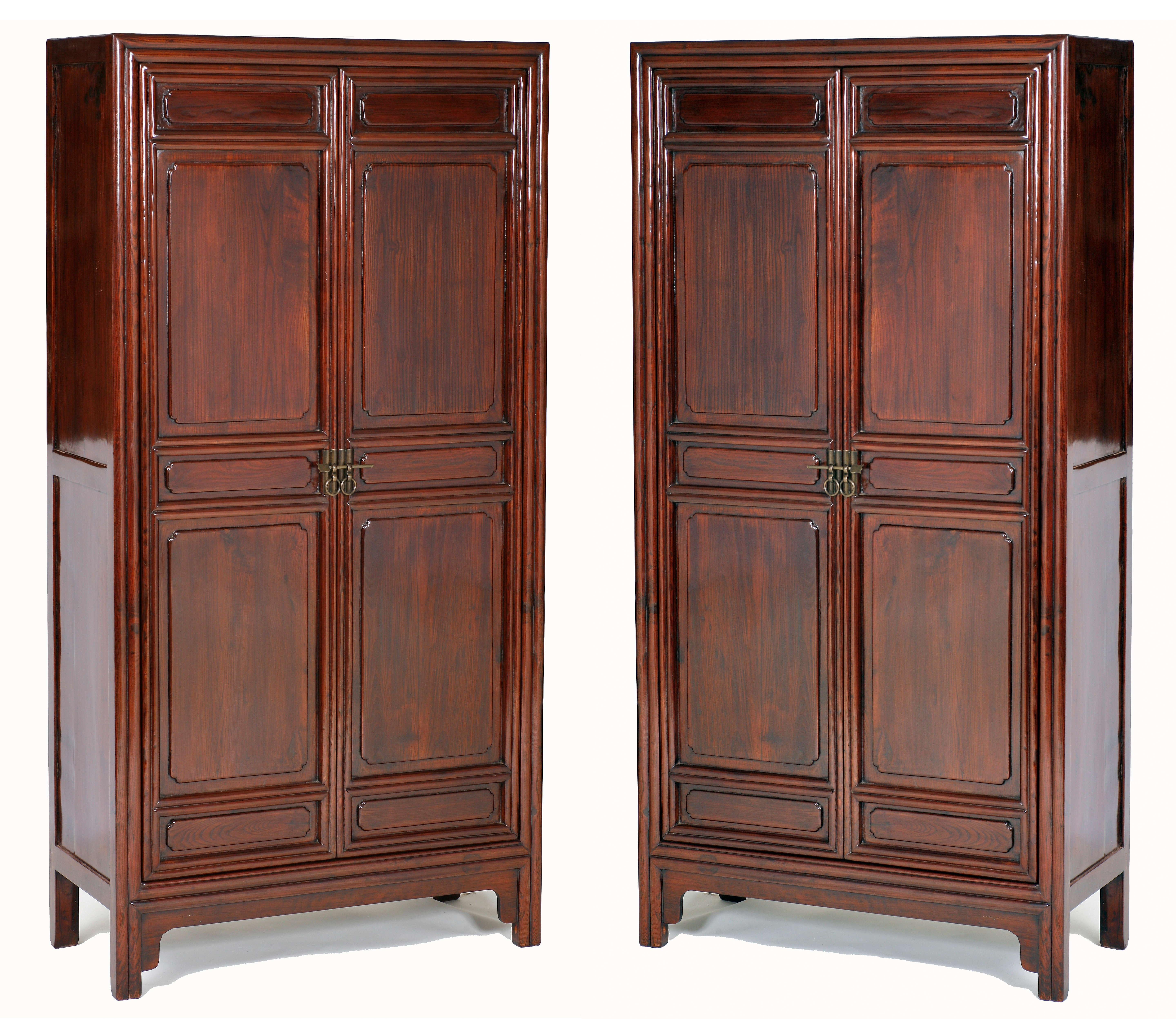The wonderful pair of square corner cabinets, carved with lipped moulding on the front posts, two doors decorated in sections with carved embossed cartouches within the carved lipped mouled frames, the doors opening to a top shelf, a mid-shelf