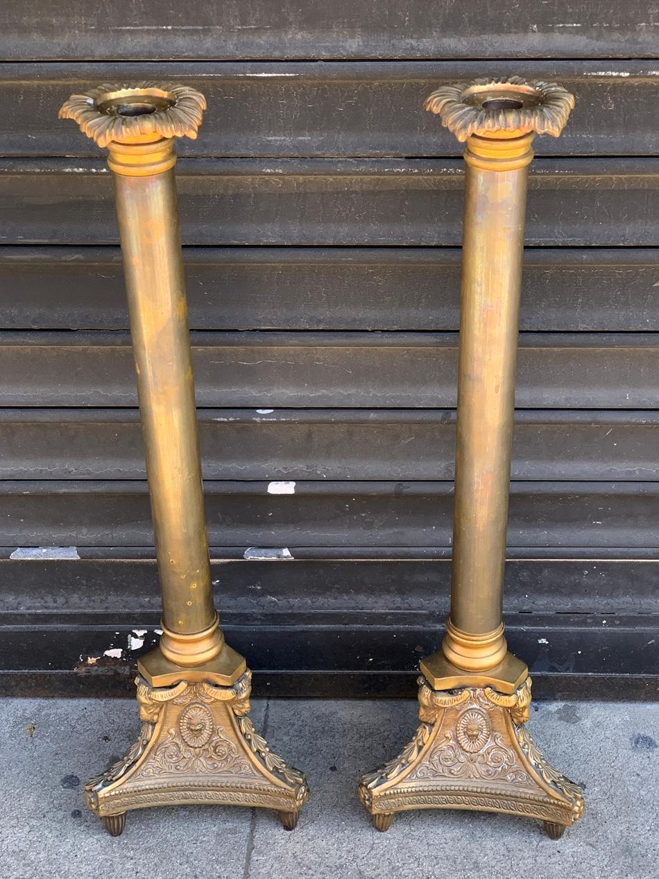 Gorgeous pair of bronze candle holders with incredible design details made in solid bronze with ram heads, flowers and other figures.

The pieces are marked A.K. on the inside.

Measurements:
22.50 inches high x 7 inches wide x 7 inches deep x