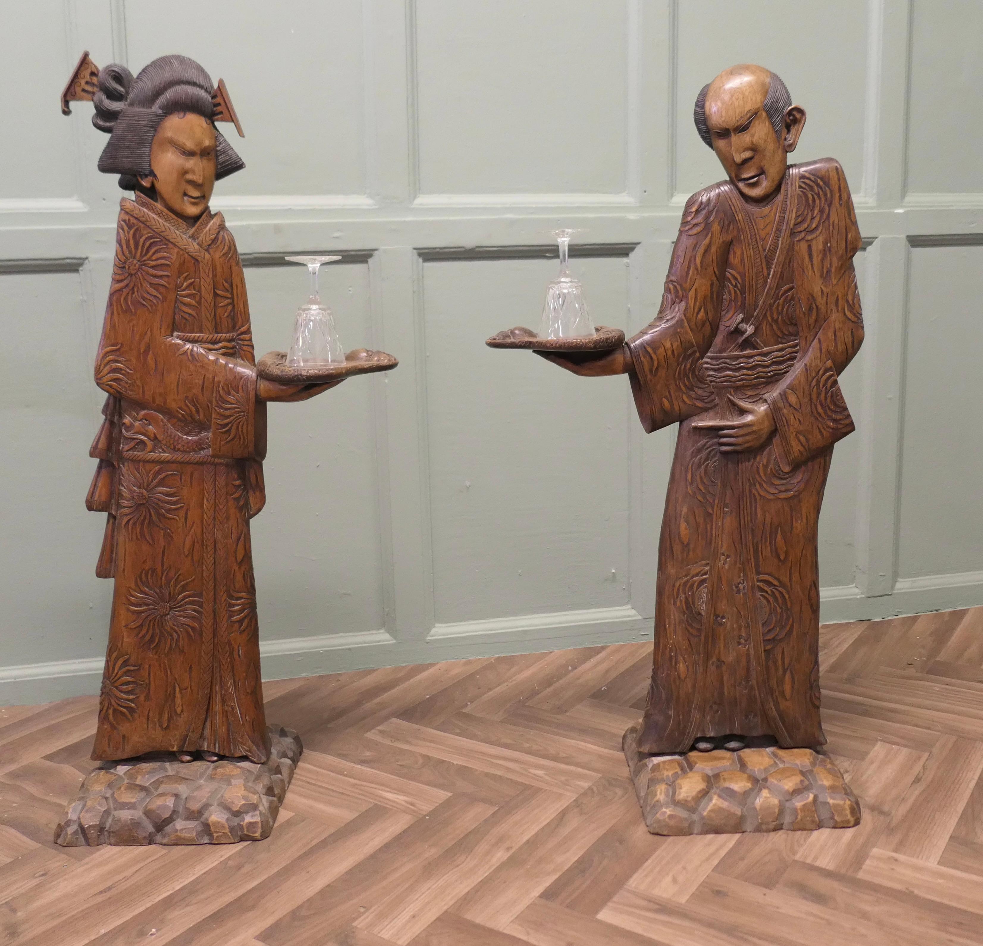 Pair of Tall Carved Japanese Figures, Dumb Waiters or Card Butler

A very Beautiful  pair of 1920s Dumb waiters, a Geisha and a Samurai, these 2 Card Butlers are hand carved, they are in 3D so look superb from all sides, the Stands are signed