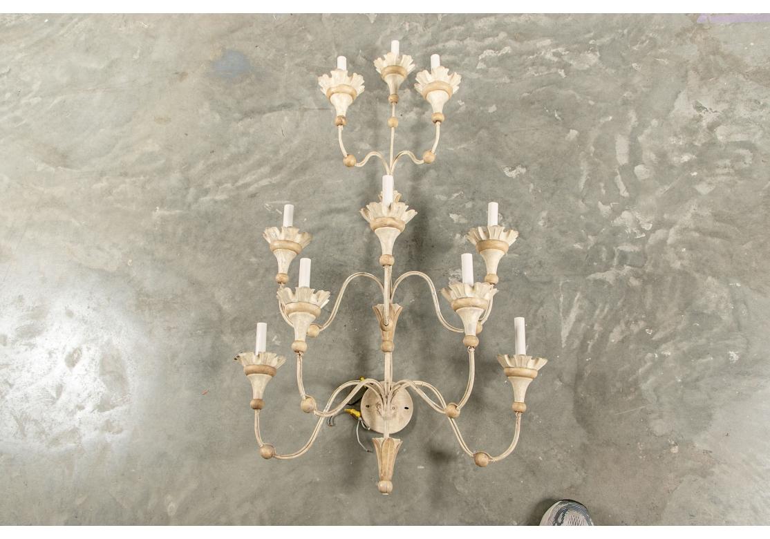 A pair of large decorative and charming tiered wall sconces in creme Paintin Provincial French manner. In a pale two tone painted finish with ten electric lights each. Four tiered with leafy bobeches. 
Measures: height 46