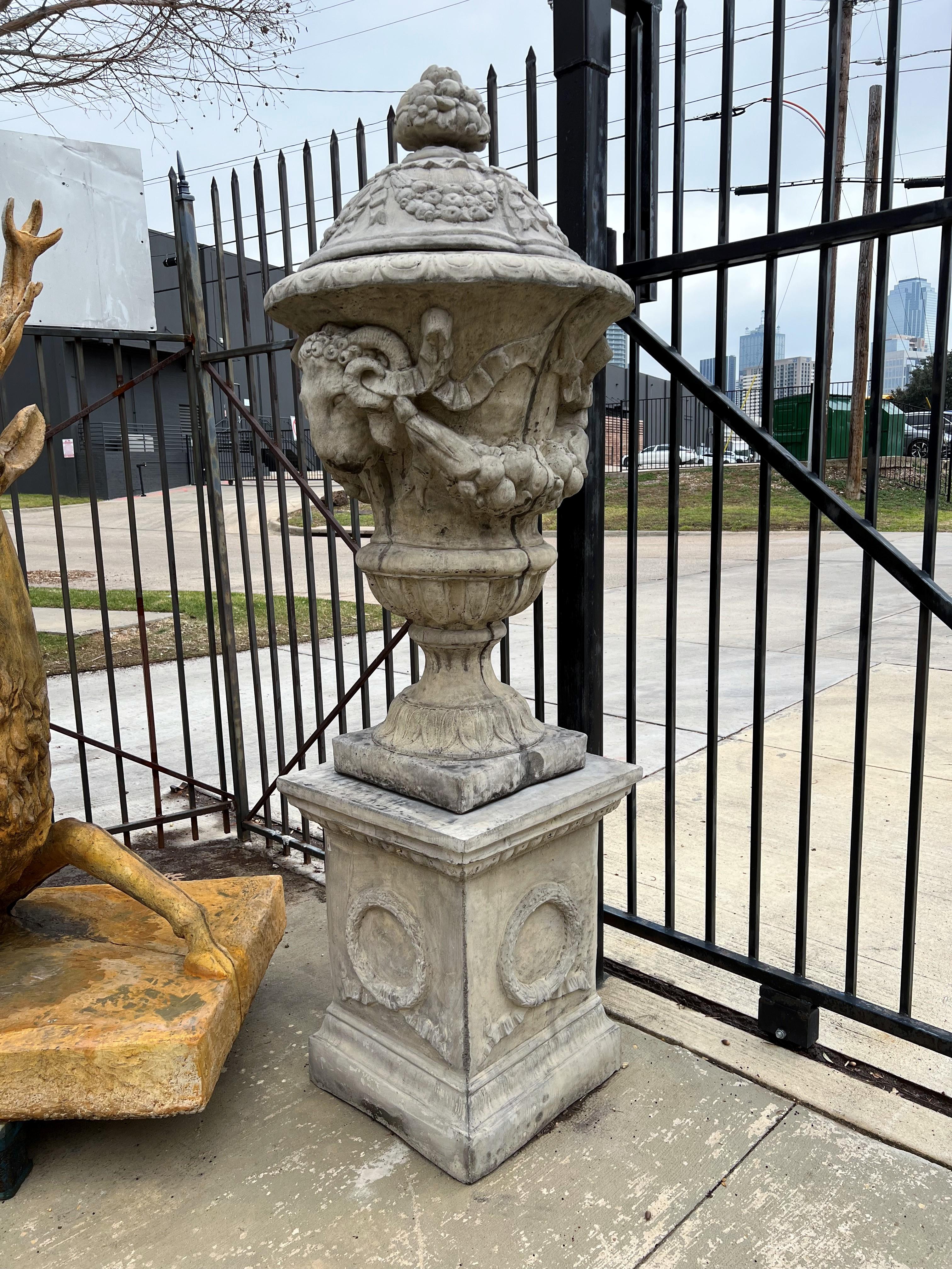 This tall pair of French garden urns measures 83 ½” tall (the pedestals are 28 7/8”, making the urns themselves 54 5/8”). They are very detailed renditions of antique originals that were carved from marble or stone. Since these are cast with a
