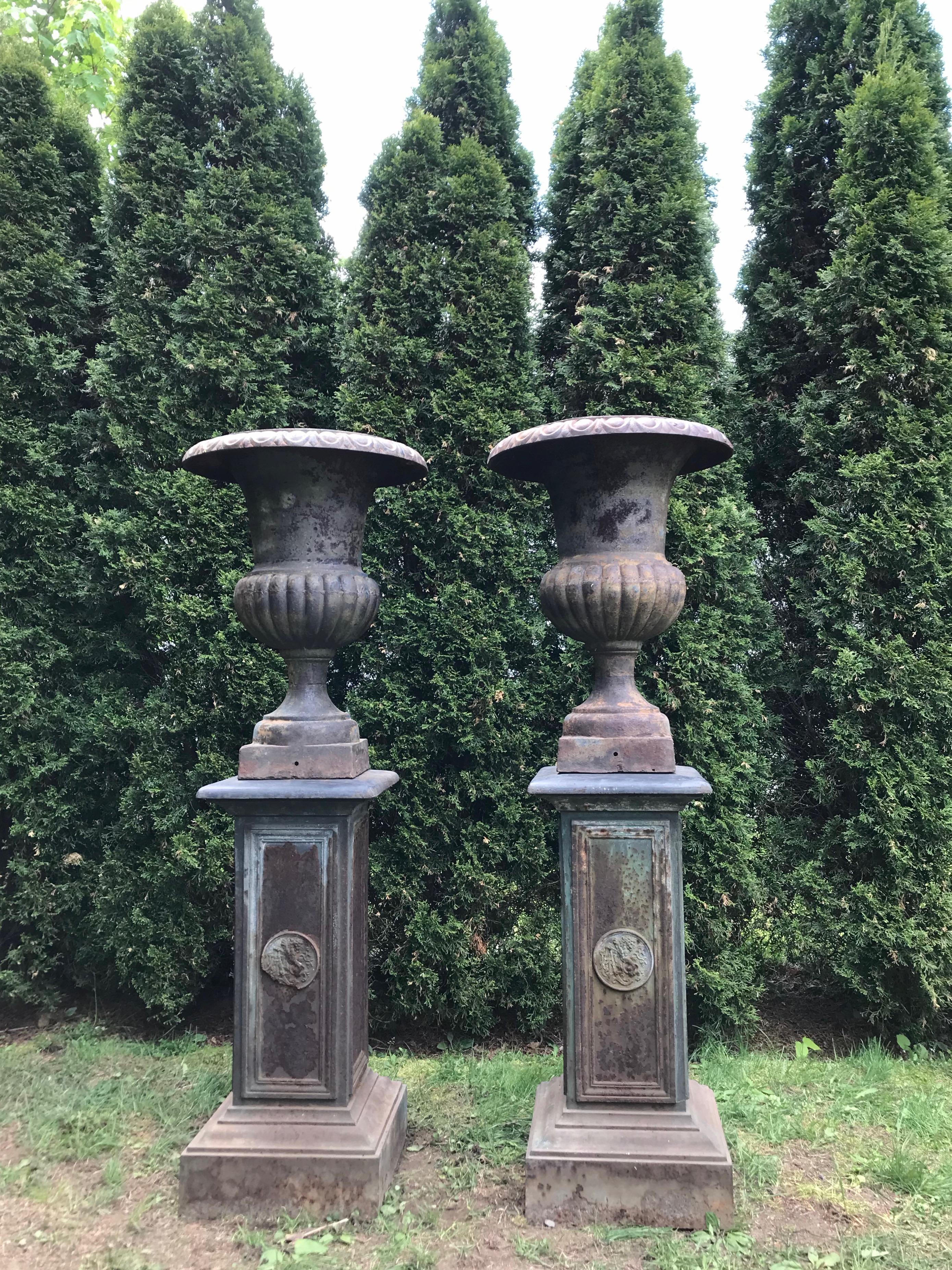 We found these urns and pedestals in different parts of France, and have made, what we think is, a very successful marriage of them. The urns, which are made of cast iron, with everted lobed rims and quarter-lobed bodies, are in excellent antique
