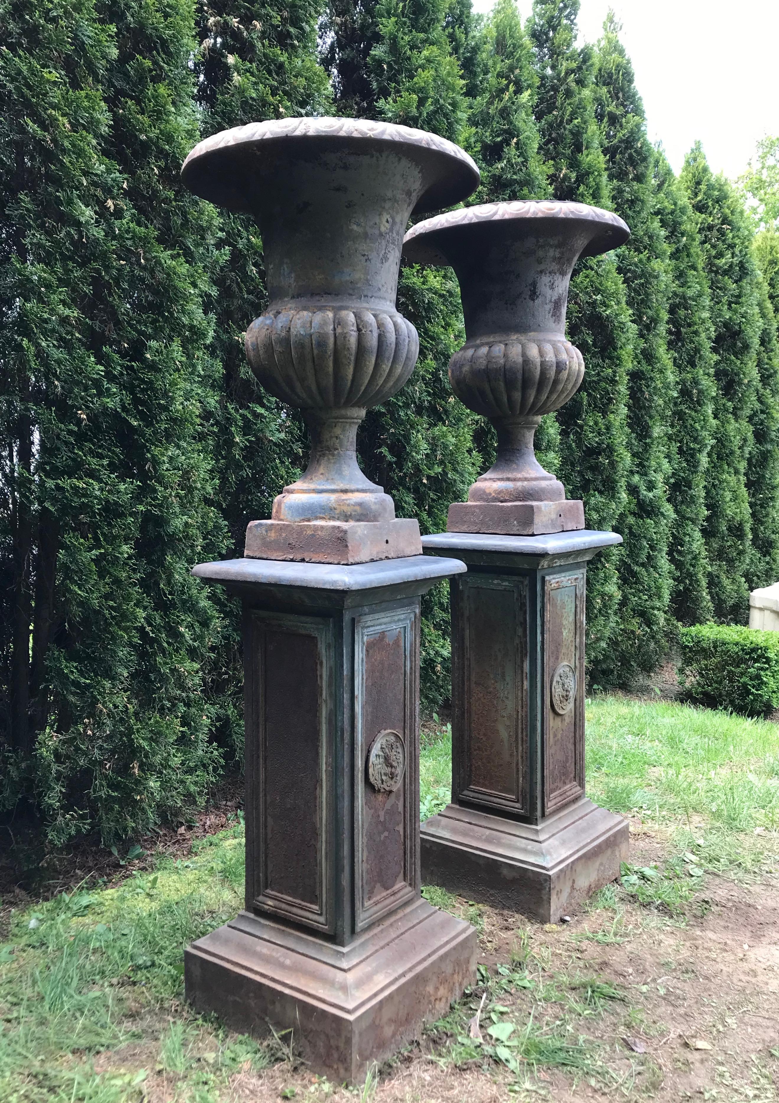 Napoleon III Pair of Tall Cast Iron Medici Urns on Pedestals with French Republic Medallions For Sale
