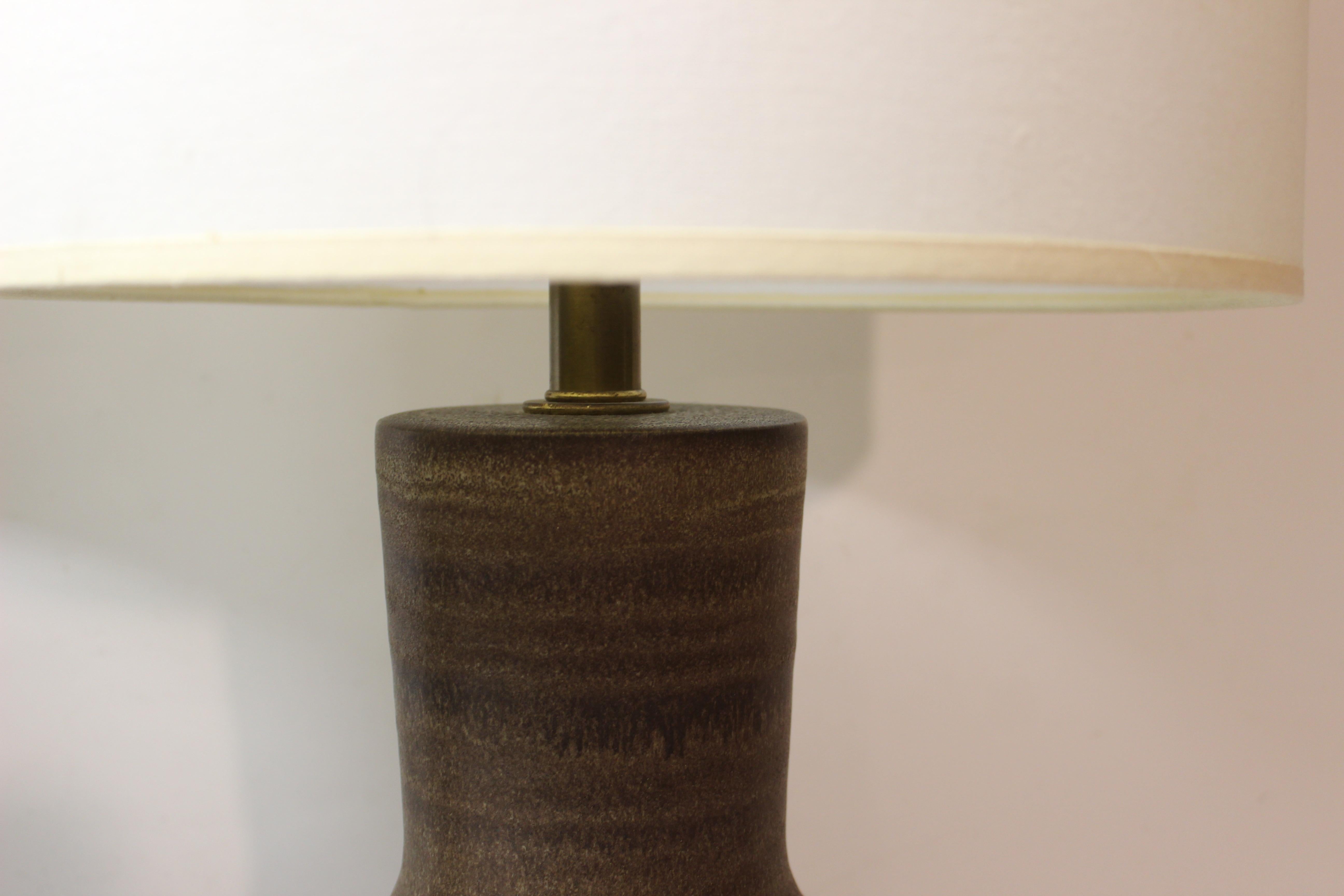 Pair of tall brown ceramic table lamps by Design Technics.

The ceramic base of the lamp measures 19.25