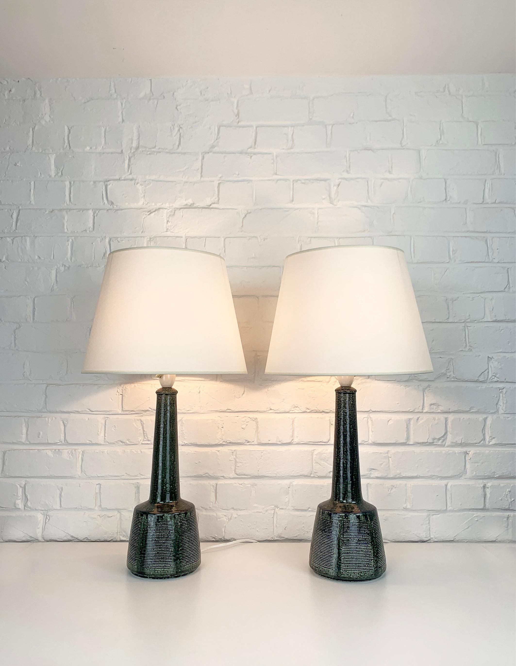 Tall pair of ceramic table lamps designed by Esben Klint. 

Esben was the son of Kaare Klint (the famous danish furniture designer). He created a timeless design with this model, it has a contemporary and graphic side despite being over 50 years