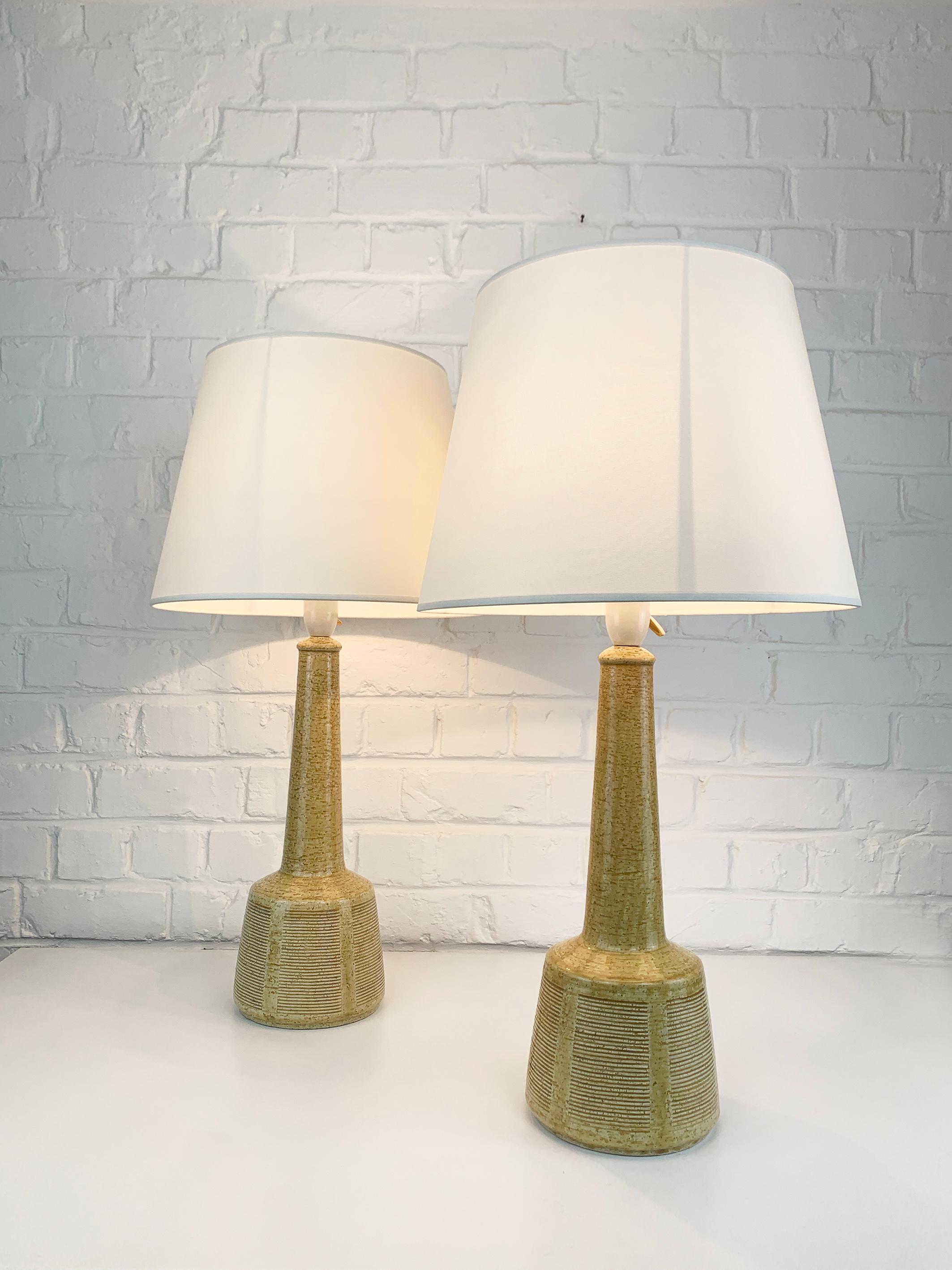 Tall pair of ceramic table lamps designed by Esben Klint. 

Esben was the son of Kaare Klint (the famous danish furniture designer). He created a timeless design with this model, it has a contemporary and graphic side despite being over 50 years