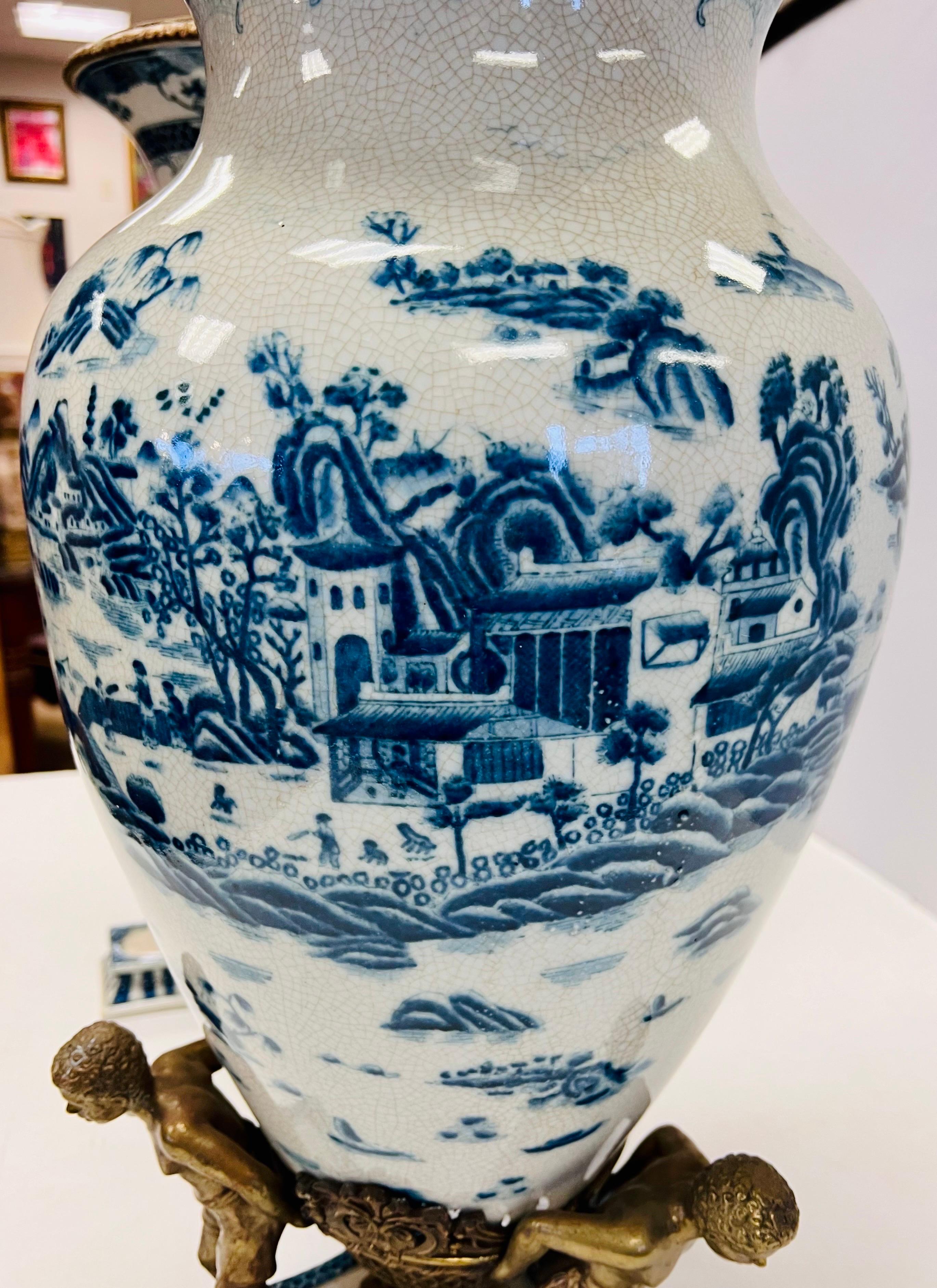 Hand-Painted Pair of Tall Chinoiserie Blue and White Urns With Bronze Figural Mounts For Sale
