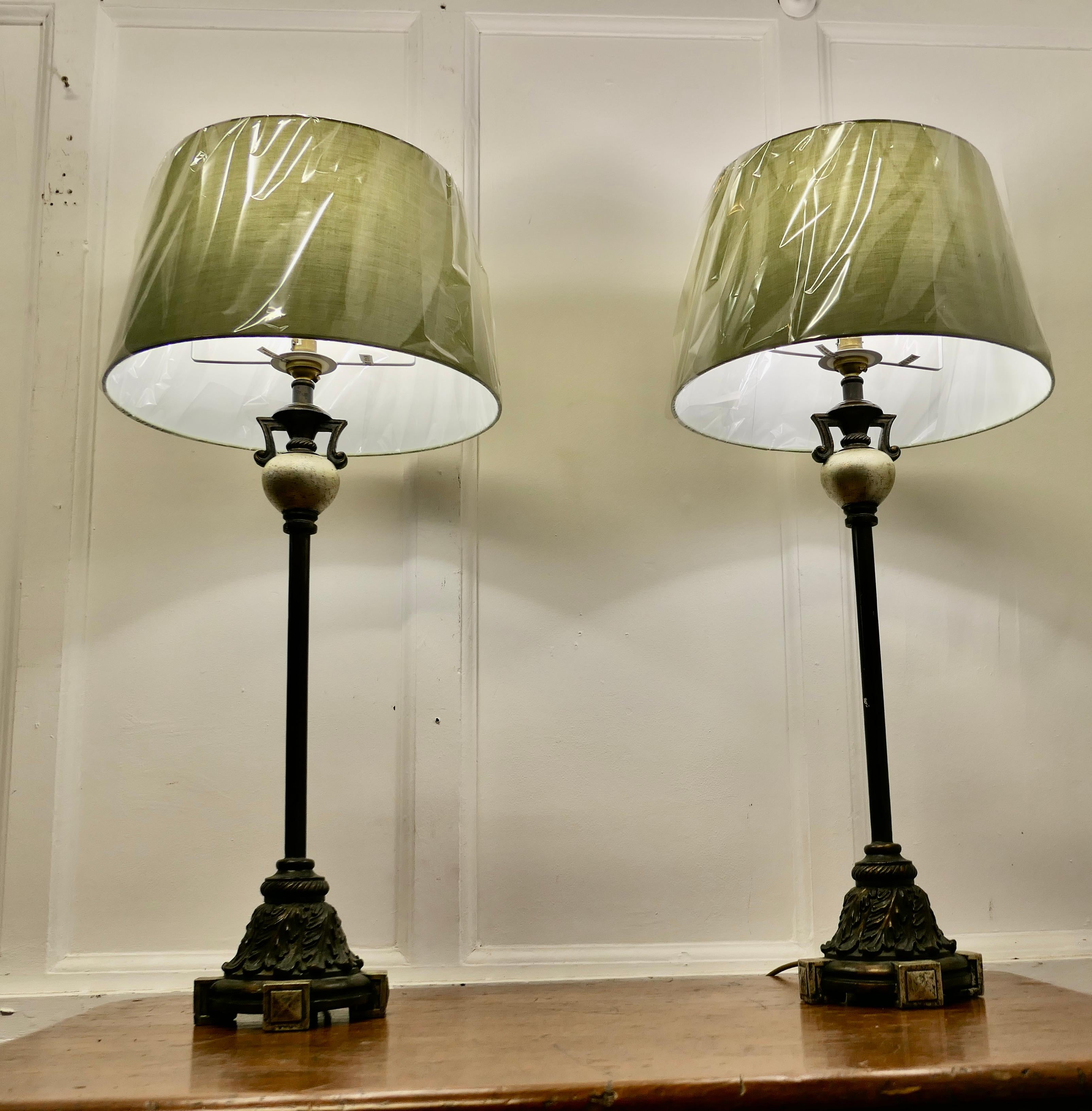 Pair of  Tall Classical Style Column Table Lamps

These are a very stylish pair of Bronzed finish column lamps
The main columns are supported on an elaborate stepped bronzed base decorated with acanthus leaves, at the top they have a more bulbous