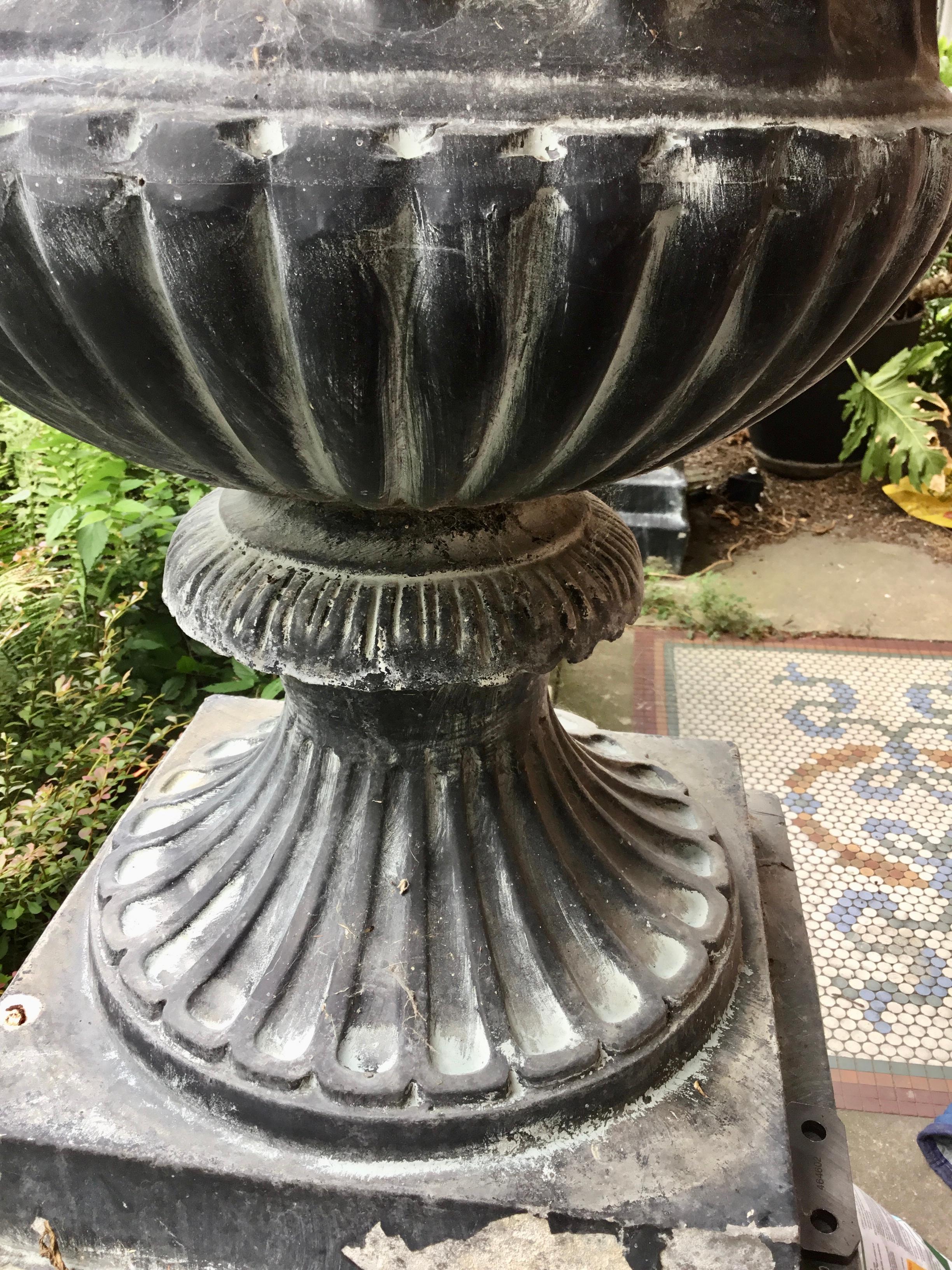 Pair of Tall Classical Styled Fluted Metal Garden Urns on Stands In Distressed Condition For Sale In Nashville, TN