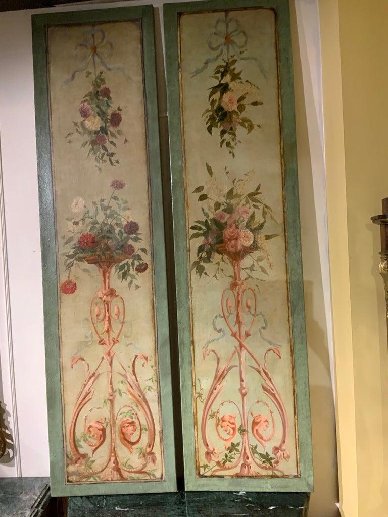 Antique oil paintings of flowers set in a tall centered urn spilling forward. A deeper green border
Surrounds these lovely pieces. A pale blue ribbon is centered at the crest.