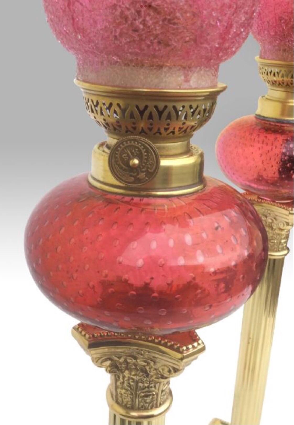 Fabulous pair of tall ruby glass peg oil lamps with painted ruby bowls and tulip ruby crackle shades.
brass corinthian column pillars.
C1900
Measures: 21.5ins. tall.