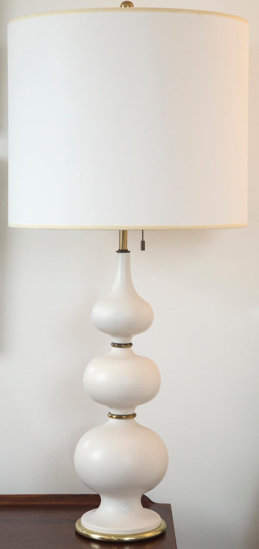 Pair of tall cream lamps by Gerald Thurston.
Measures: full lamp: 38