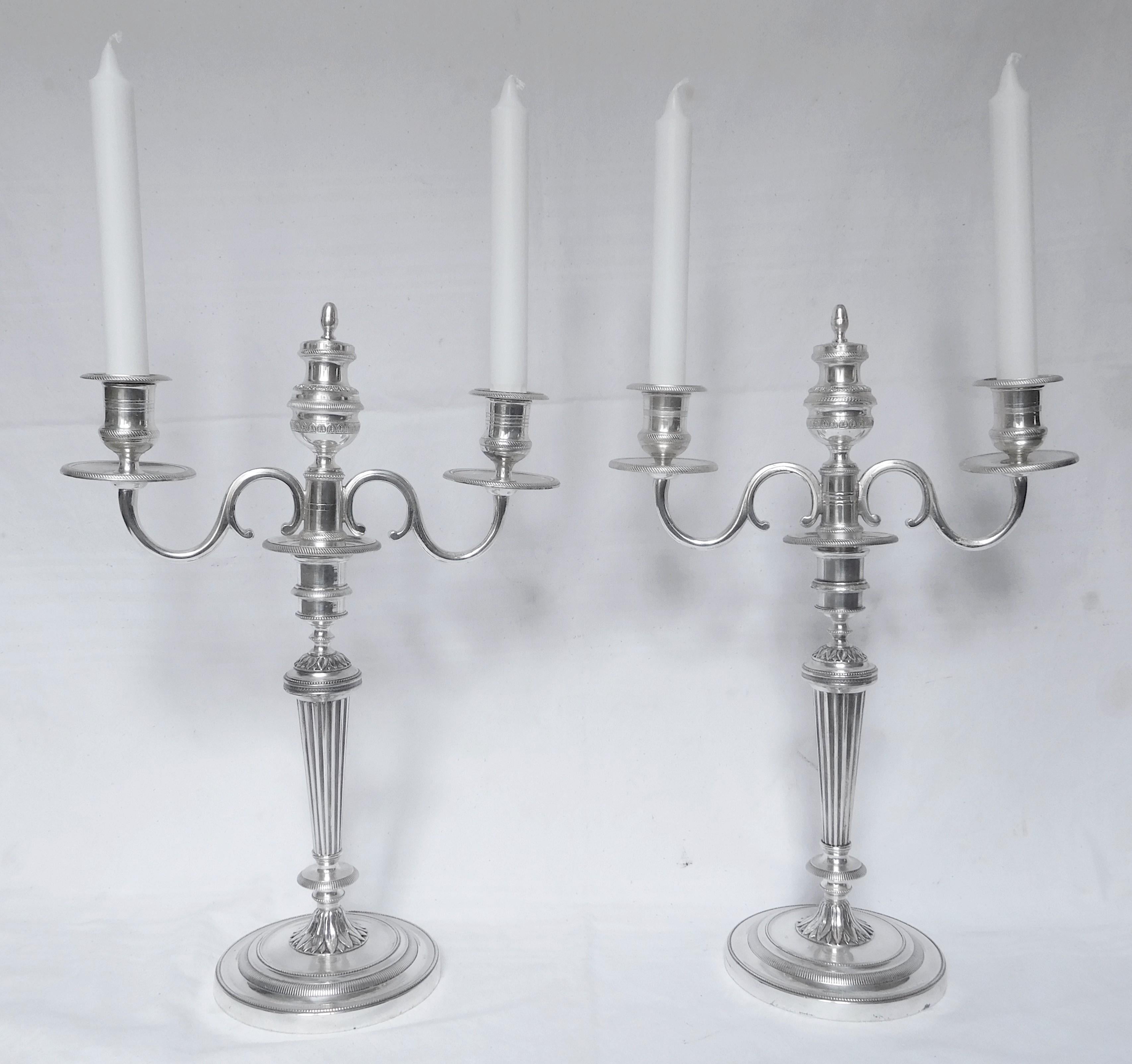 Rare pair of silver plate bronze candelabras, early 19th century production (Empire period).
Beautiful Louis XVI style model, elegant proportions, 2 to 3 lights each (you can turn the center piece over to get a third light).
They are composed of 17