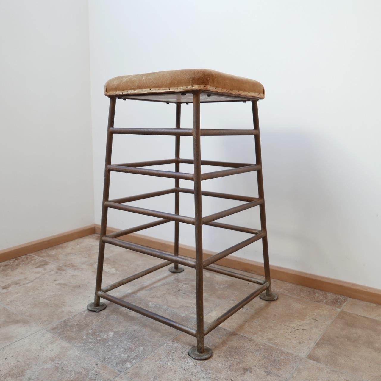 A pair of tall stools.

English, circa 1930s.

Metal and suede. Originally used in a gym or English school. 

Good patina, small bit of damage to the suede of one of the stools (see photo).

Dimensions: 90 H x 59 D x 59 W in cm.