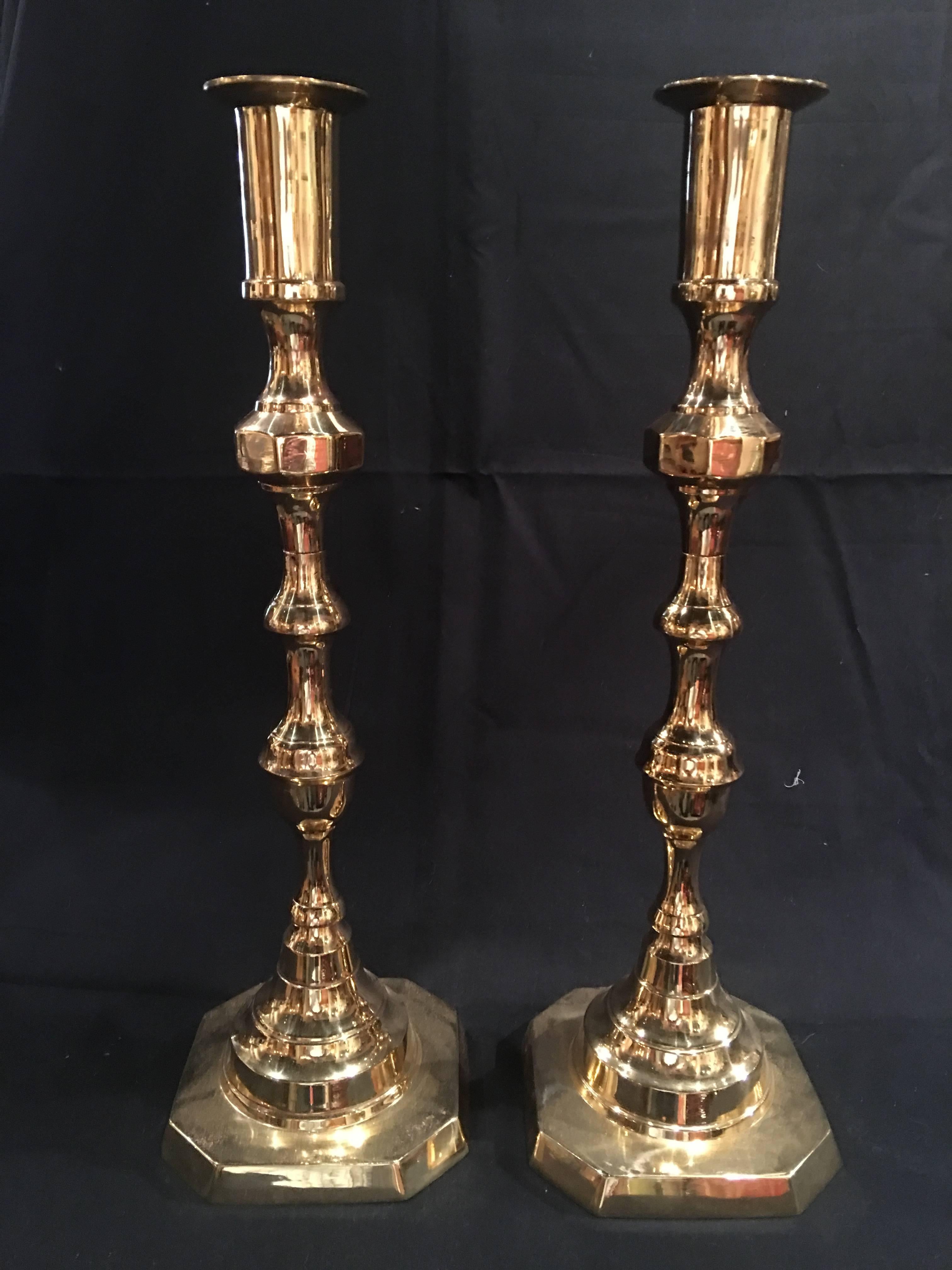 Pair of tall English polished brass candlesticks, 19th century.