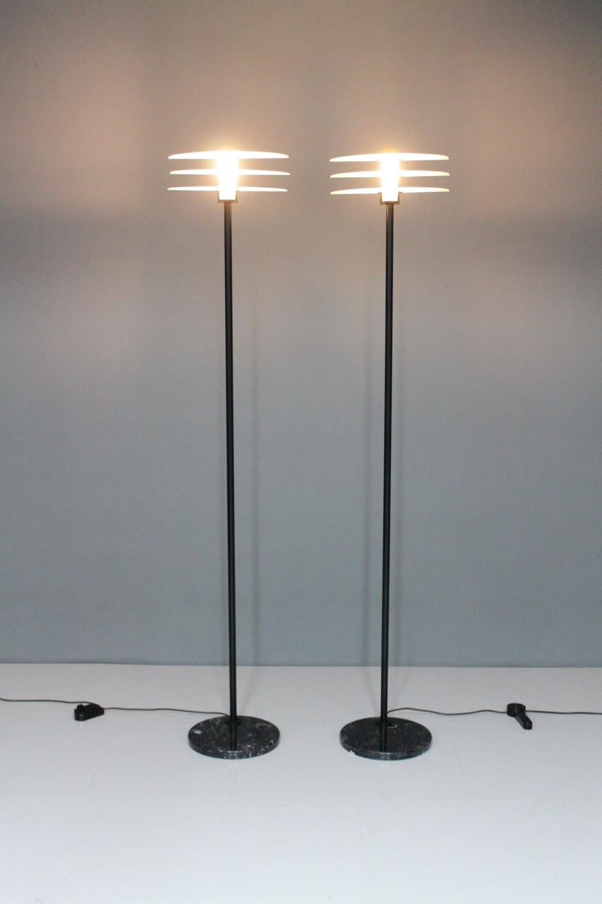 Pair of tall modern floor lamps with black marble base, metal and glass, Italy, 1990s.
Good to very good condition.