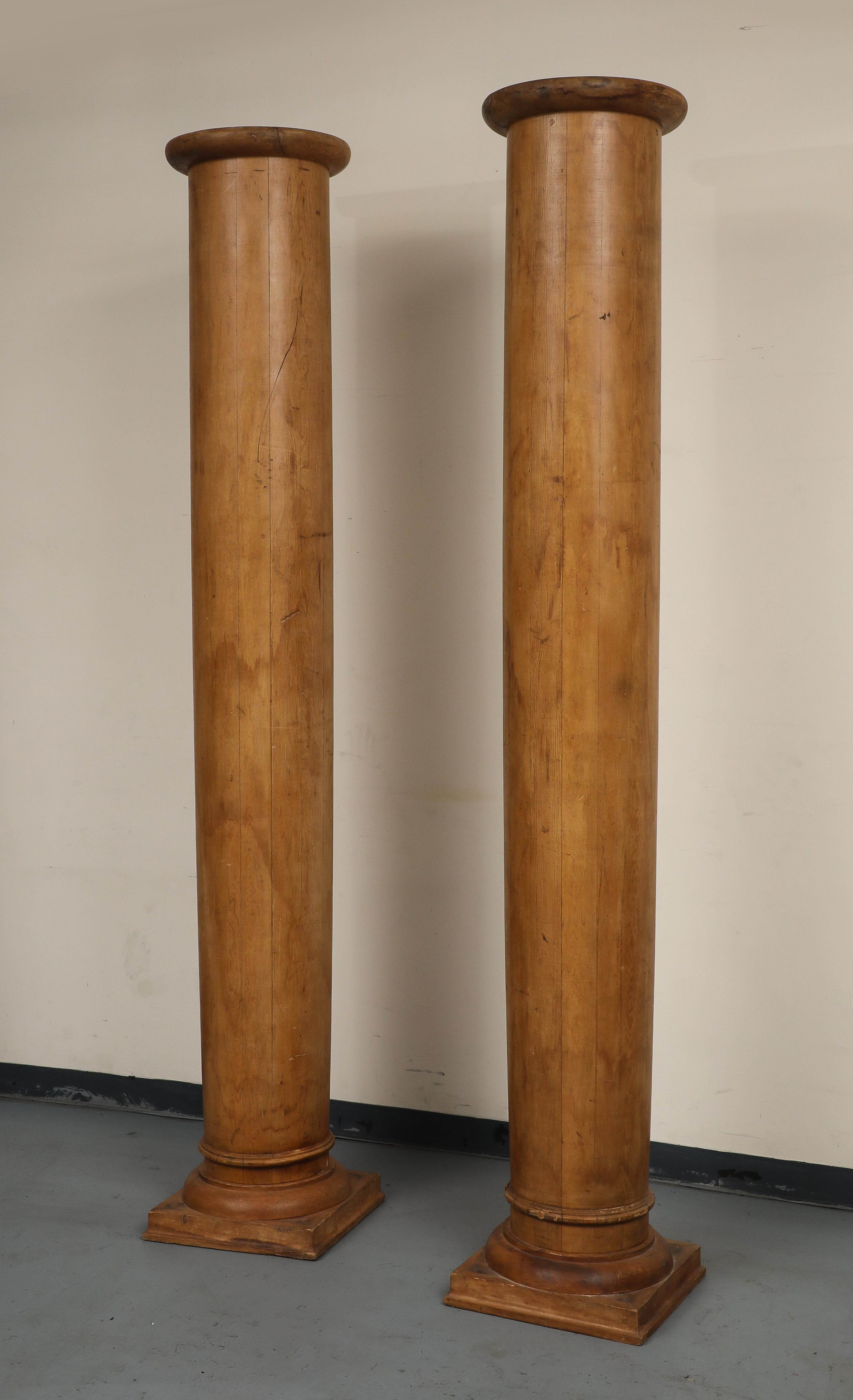 Impressive pair of decorative pine columns, each standing just under 9-feet high. Crafted in the 1930s from high-quality pine in a warm, natural finish, the columns feature a classic fluted design, adding elegance and grandeur to any space.  

The
