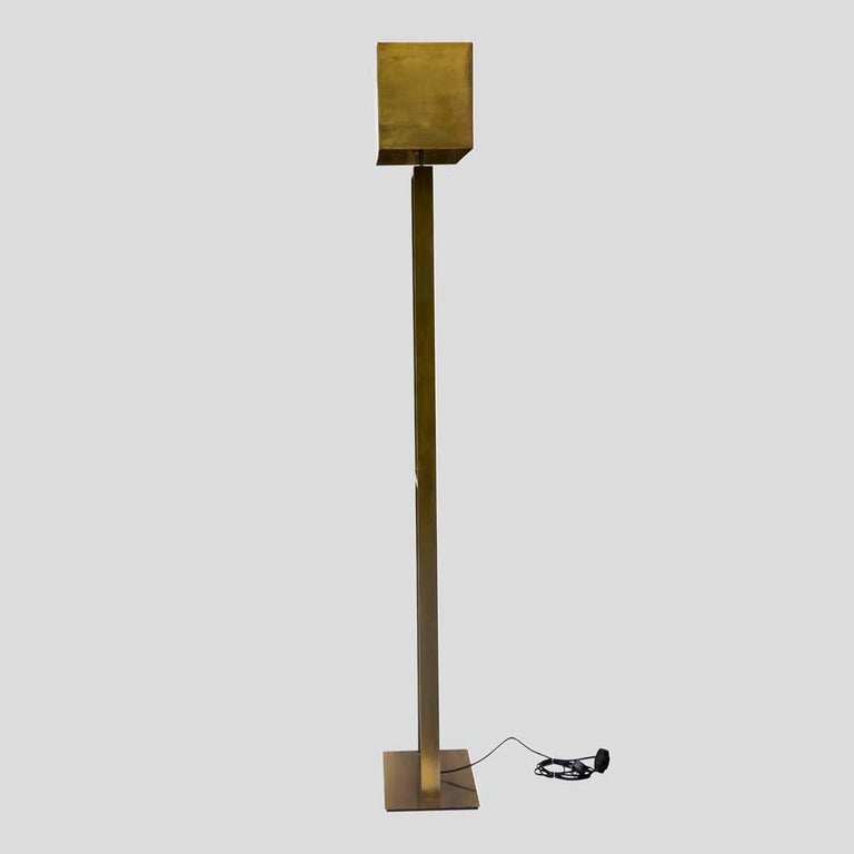 An elegant pair of 1980s floor lamps, oxidised brass rectangular structure including rectangular clear glass components on a rectangular brass base with a brass shade. The central glass block pivots. Very handcrafted Made in Italy Fontana Arte