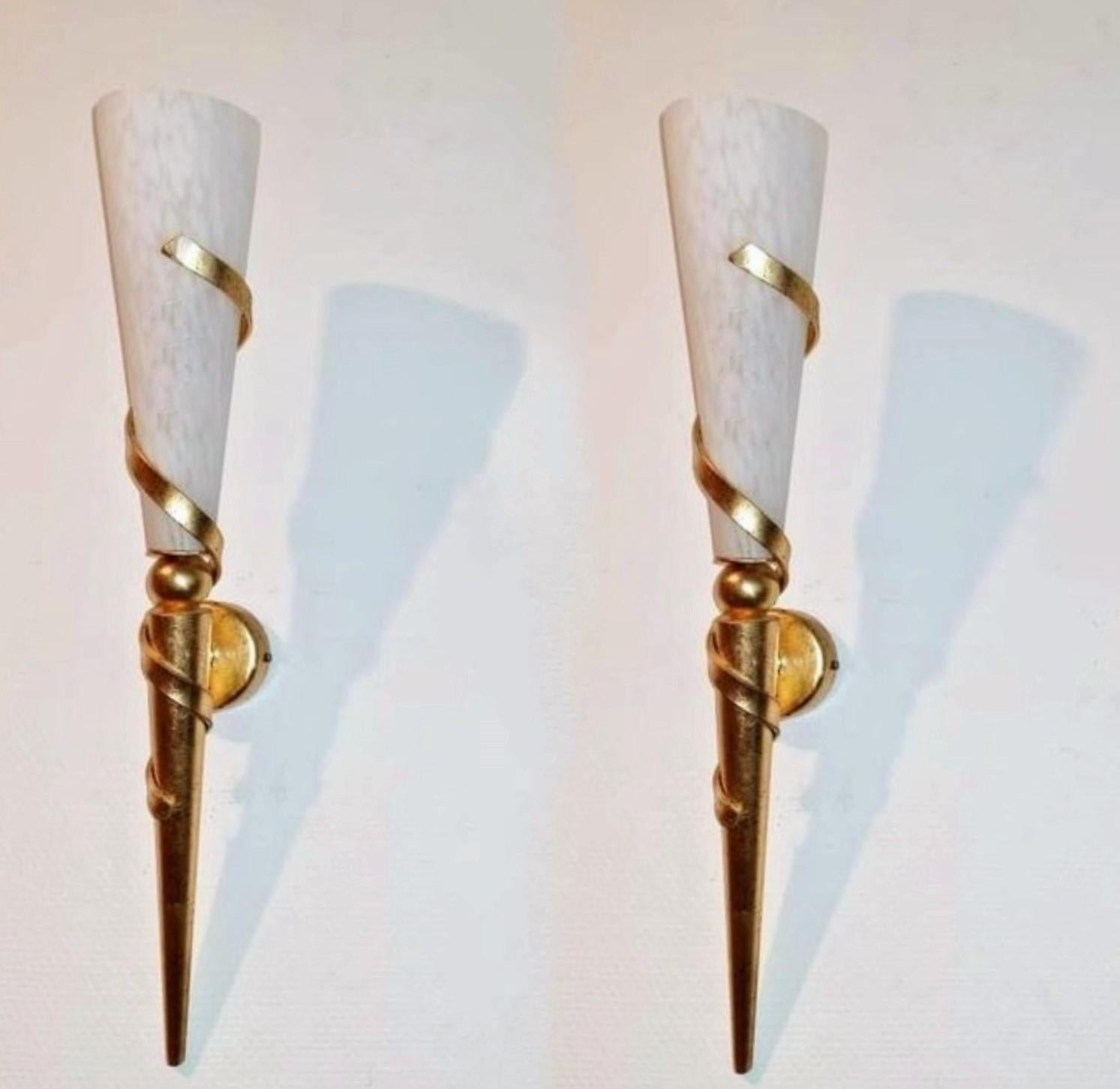A pair of tall Art Deco torchiere sconces, France 1930s. Very elegant design made of gilded iron parcel metal with conical marbled white glass. The torchieres are 24