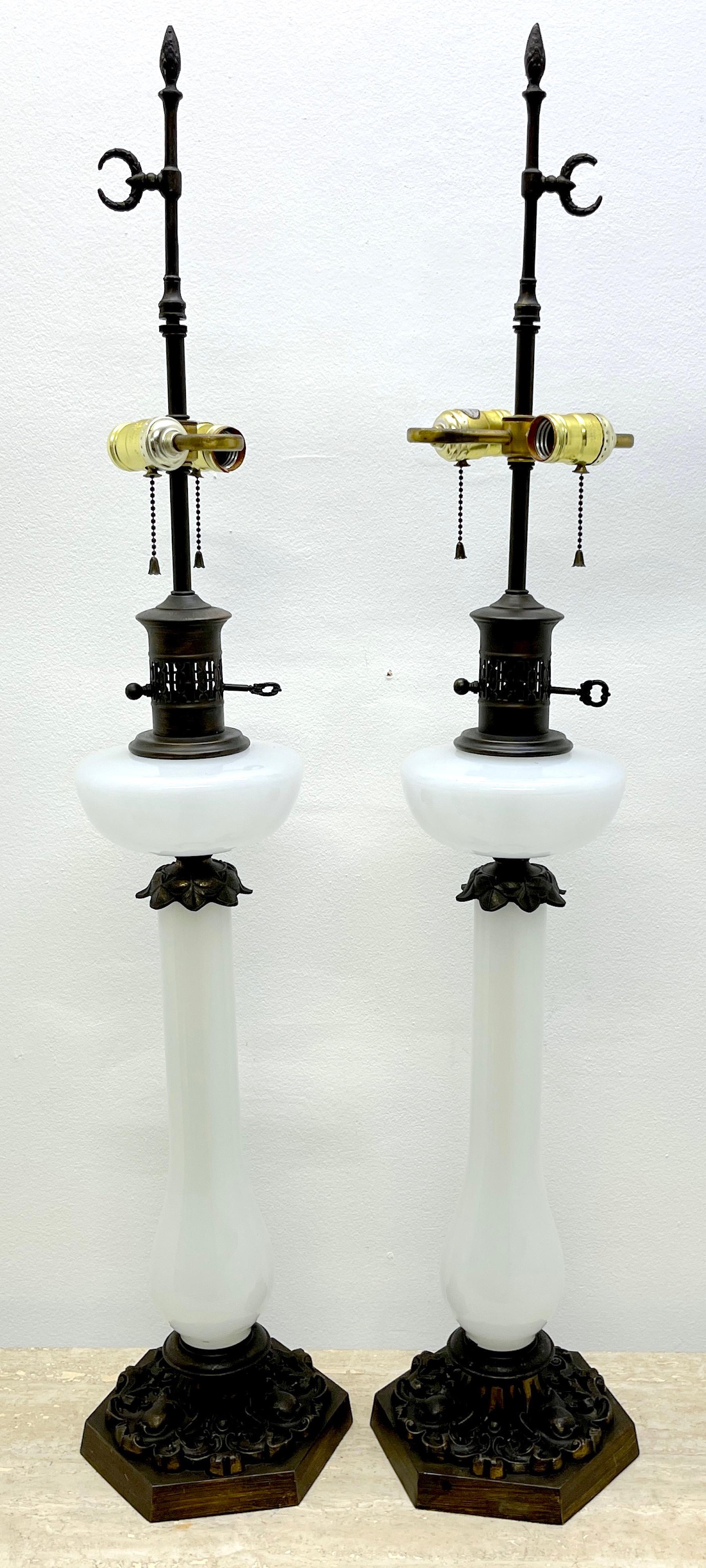 Pair of Tall French Neoclassical Opaline Oil Lamps, Now Electrified 
Oil Lamps later 19th century, Electrified 1960s 

Each one standing 40 inches tall with wreath crescent finials, fitted with neoclassical patinated metal mounts, fitted for