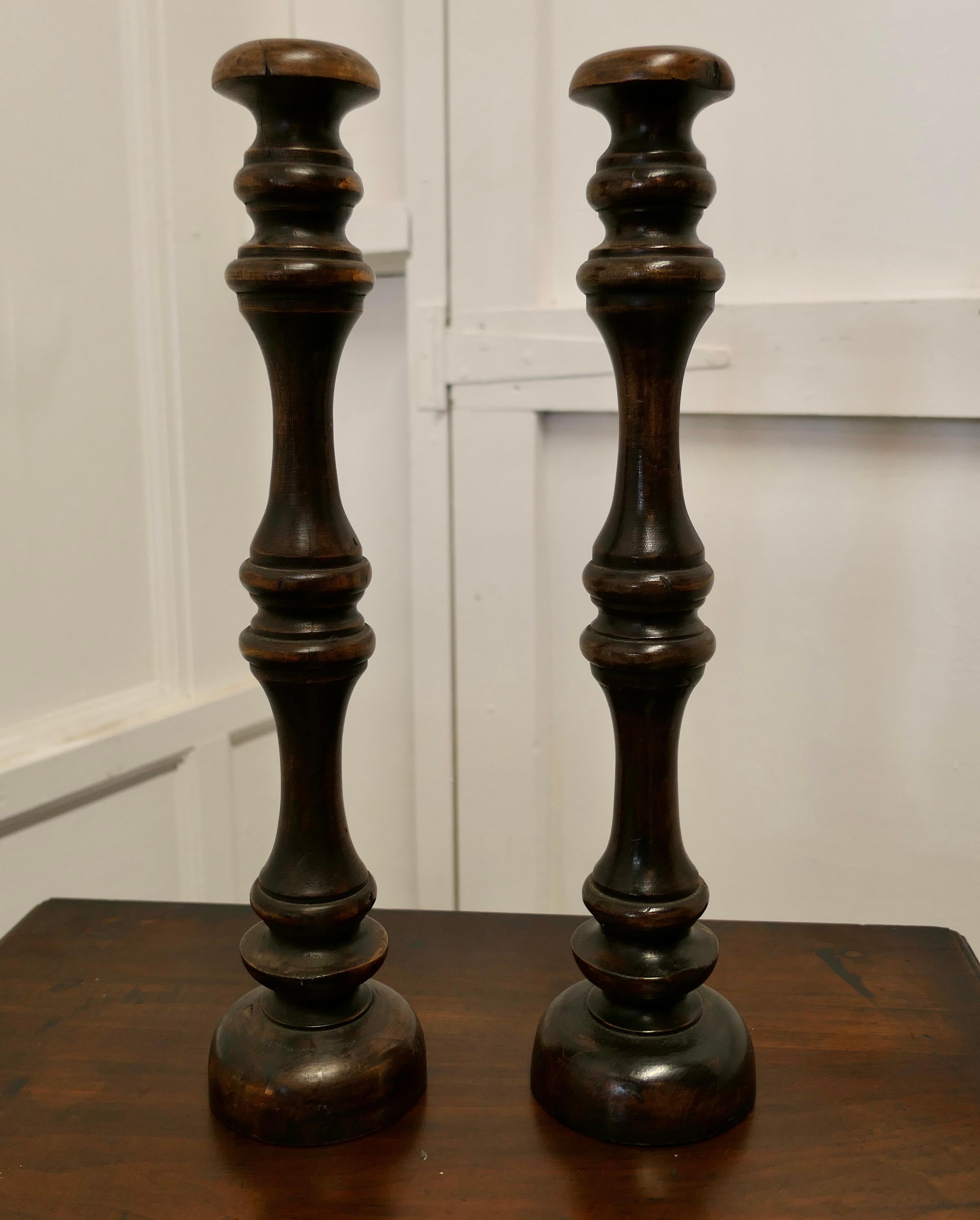 Pair of tall French turned wooden wig stands, shop display Hats

This is a superb Pair of high turned Wig Stands, they date from the late 19th Century, they have a long one piece turned upright column with a curved top rest set on a turned round