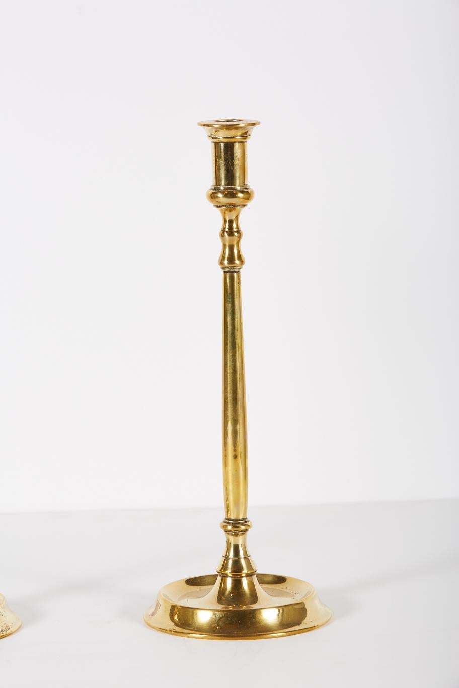 Pair of tall heavy weight Georgian of early Victorian style brass candlesticks.
