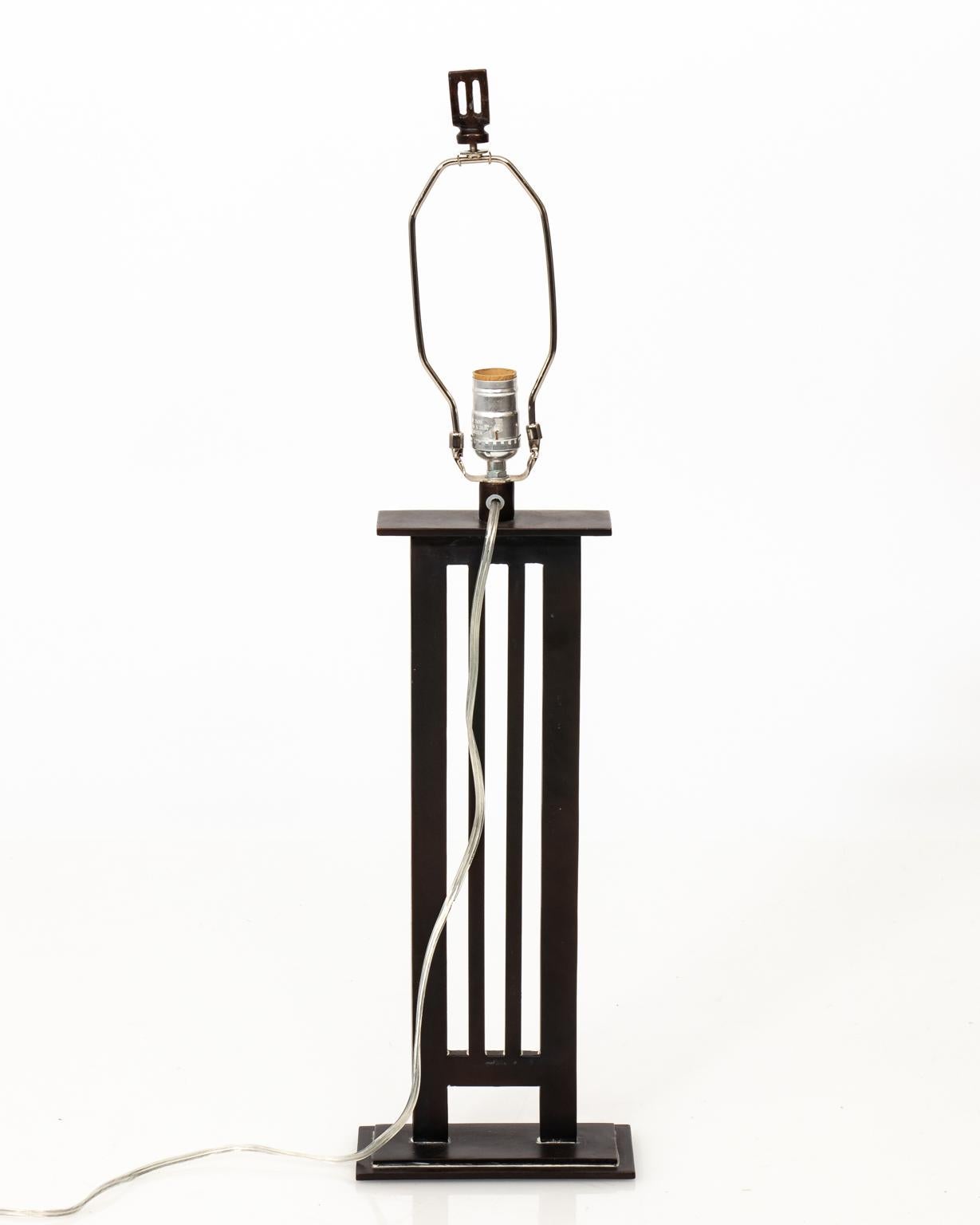 Contemporary pair of Iron column lamps with decorative drum shades in a black and white tribal print.
   