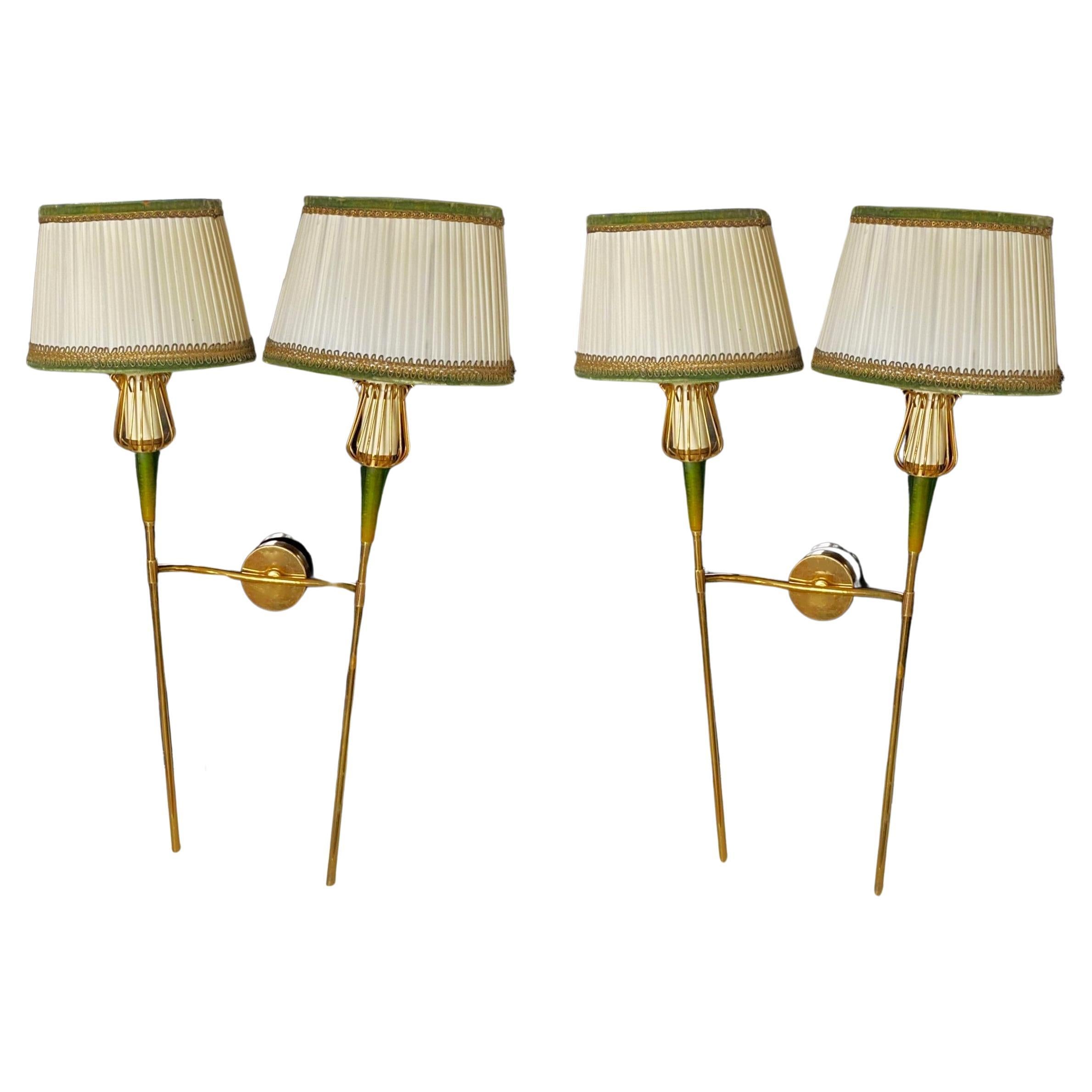 A pair of tall two-arm wall sconces by Maison Lunel, France, 1950s. Very elegant and timeless design in gilt brass with green lucite accents, four original silk shades in ivory color with green velvet and gold edges. Both pieces are in good original
