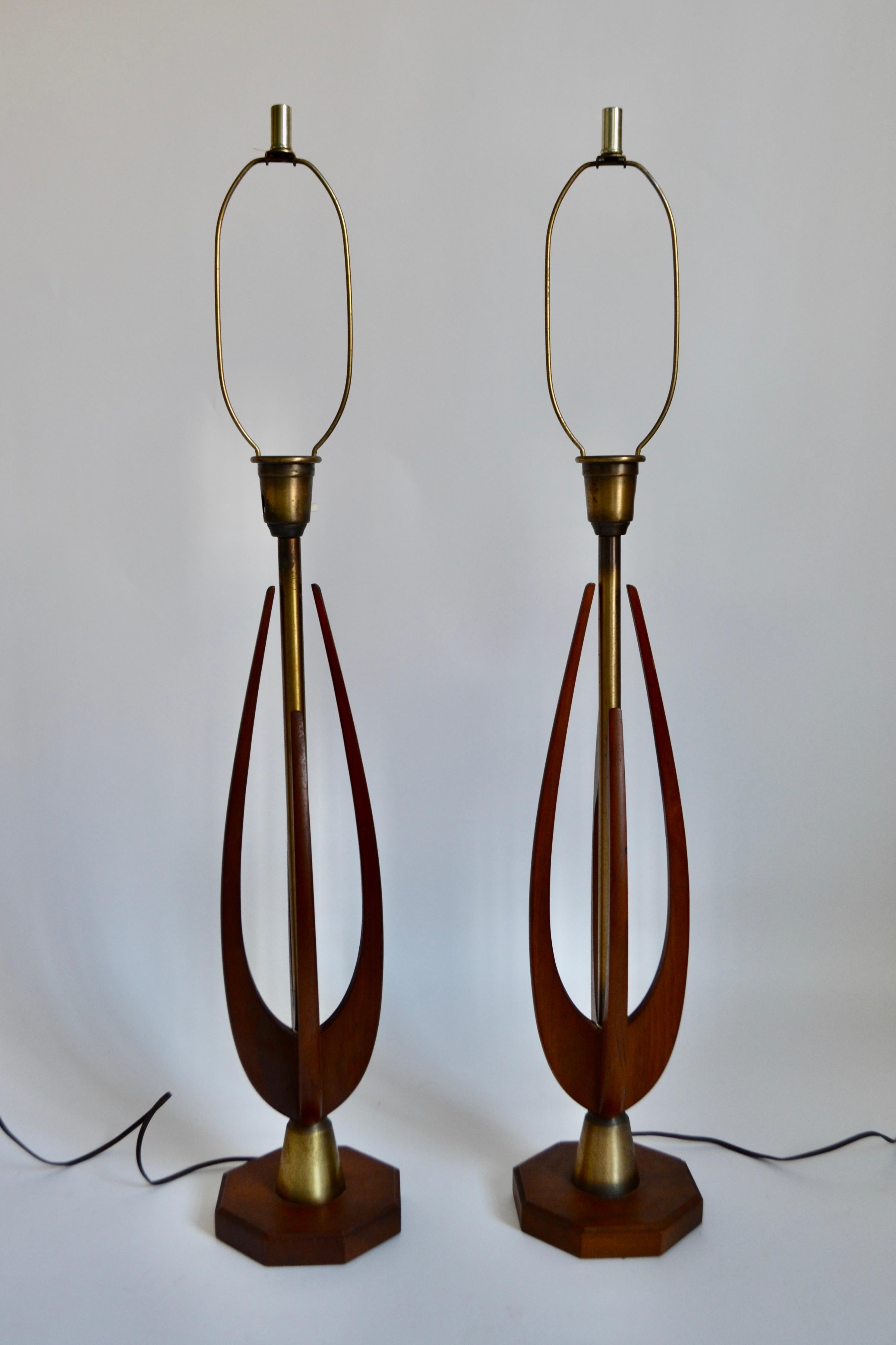 A particularly striking and tall, elegant pair of 1960s Danish solid walnut table lamps of sculptural form with a brass central column. UK plug.