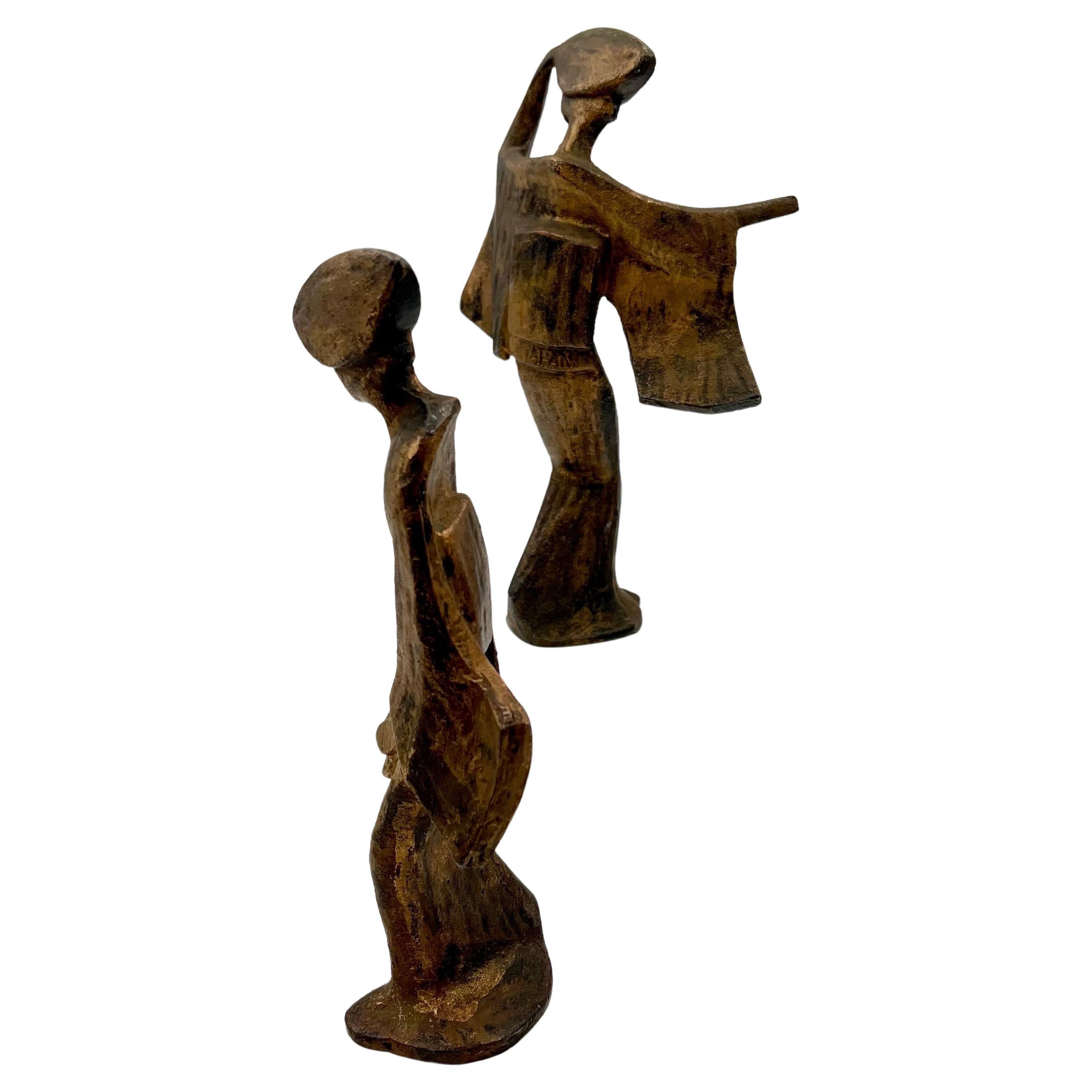 A very cool pair of Japanese geisha figurines, circa 1960s. The pieces are cast iron with a gold finish and are quite heavy and taller than the regular ones they would make a great Mid-Century Modern accent in any space.