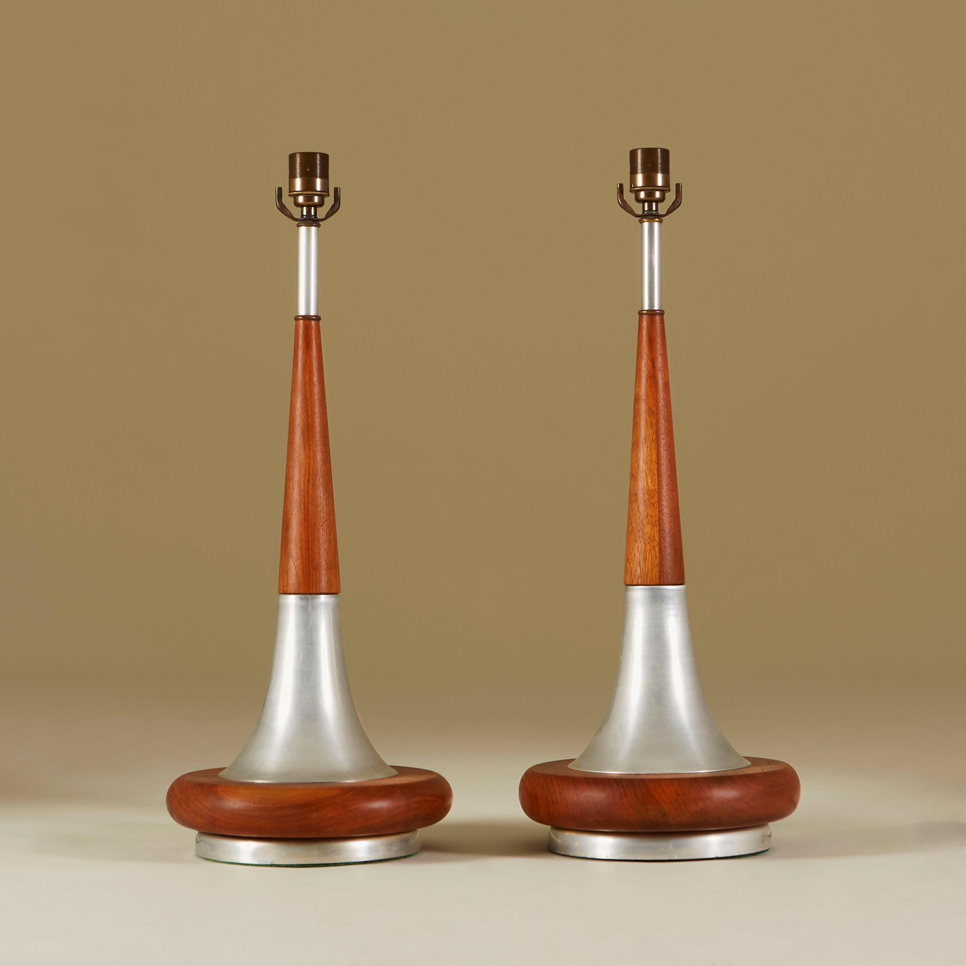 Tapered lamps with interspersed chrome and walnut detail. Sits on circular walnut and chrome base. Complete with original shades.


Size without shades: 67cm high x 26cm diameter base.