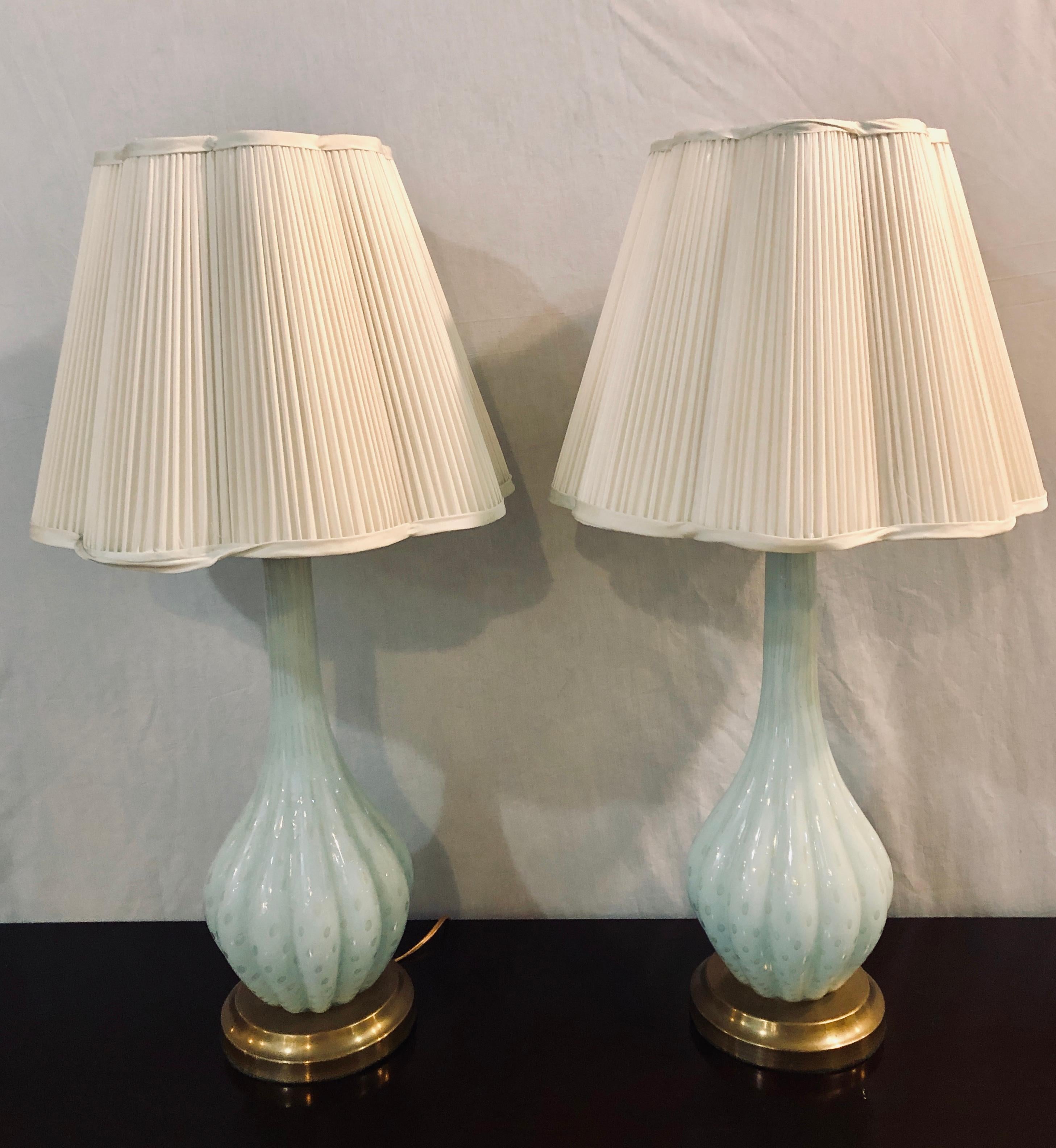Pair of Murano glass white blue color table lamps. Each having a custom made shade and each takes one bulb. The pair sitting on a brass base. Recently rewired.