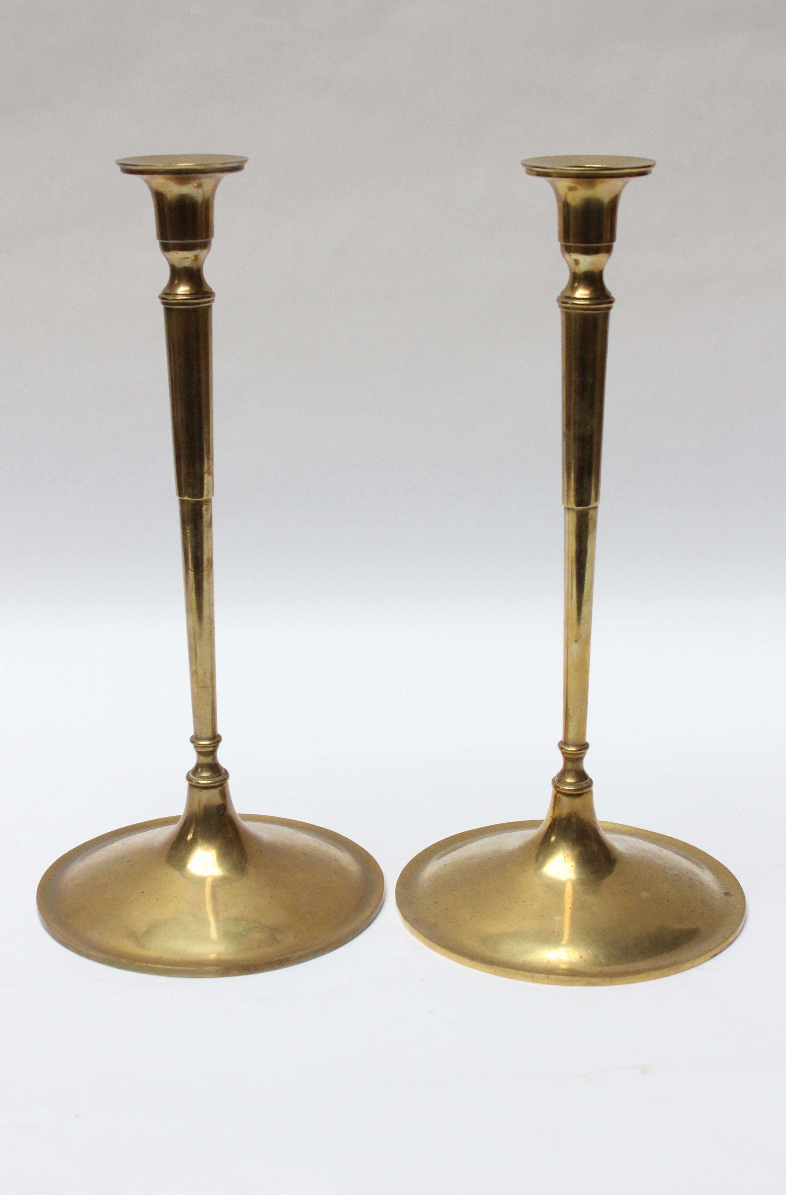Tall Art & Crafts style brass turned candlesticks with wide circular bases designed by Nashua Brass Co. (ca. 1920s, USA).
Original, unpolished condition with rich patina / age-consistent wear (particularly to the stems and bases), as