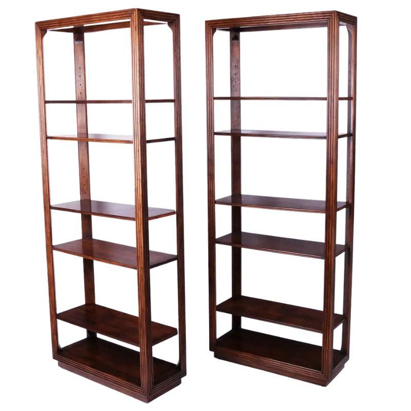 A pair of tall oak multi shelf etageres with a reeded frame on all sides.  The dark wood six shelf bookcases are open on all sides and the shelf heights are adjustable. 