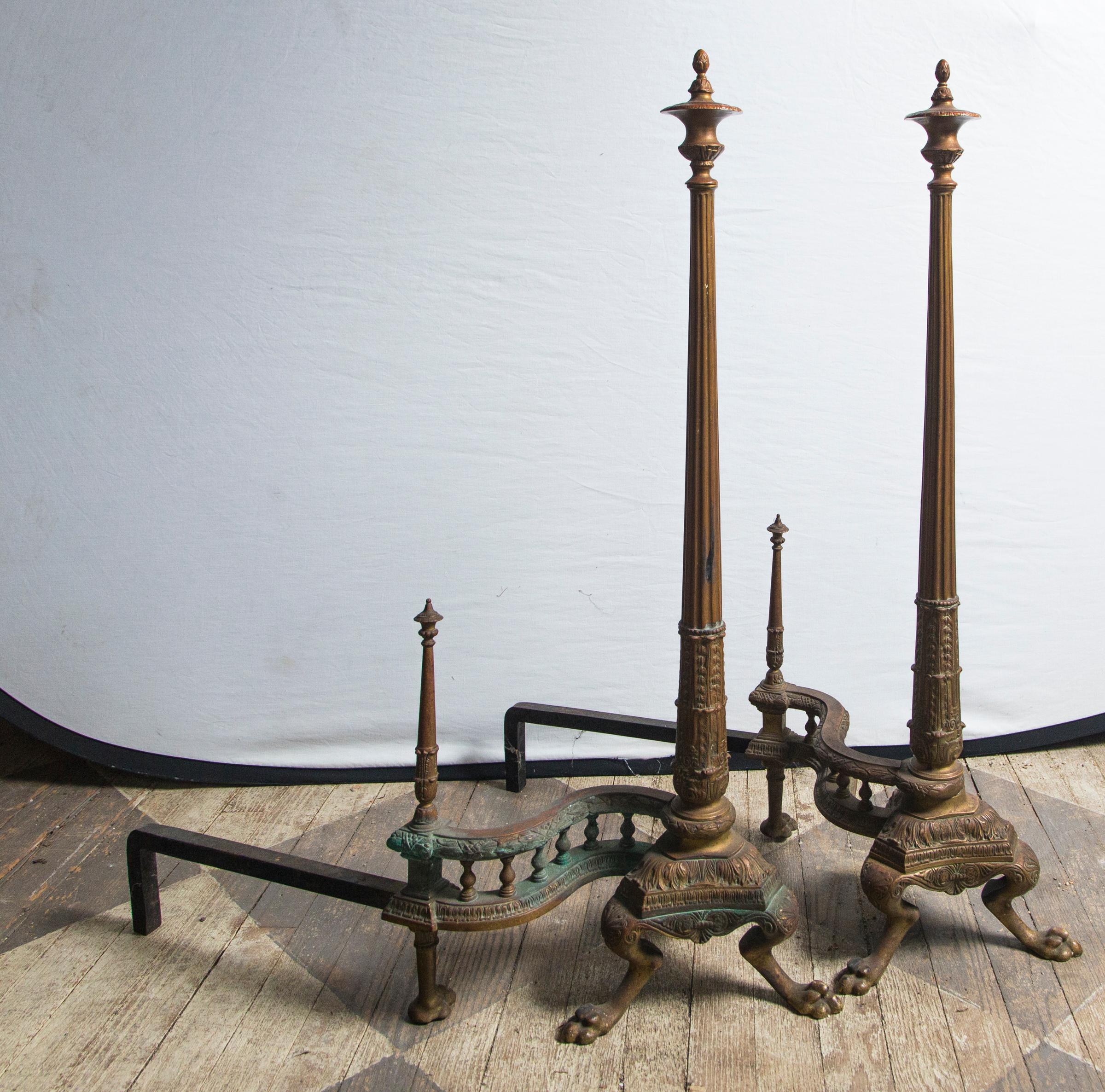 Each topped with an urn shaped finial, above a tall slender and tapered fluted column, that end with acanthus leaves, the columns are attached to a tripartite base ending in paw feet. The whole attached to a long, 2-tier gate with urn form